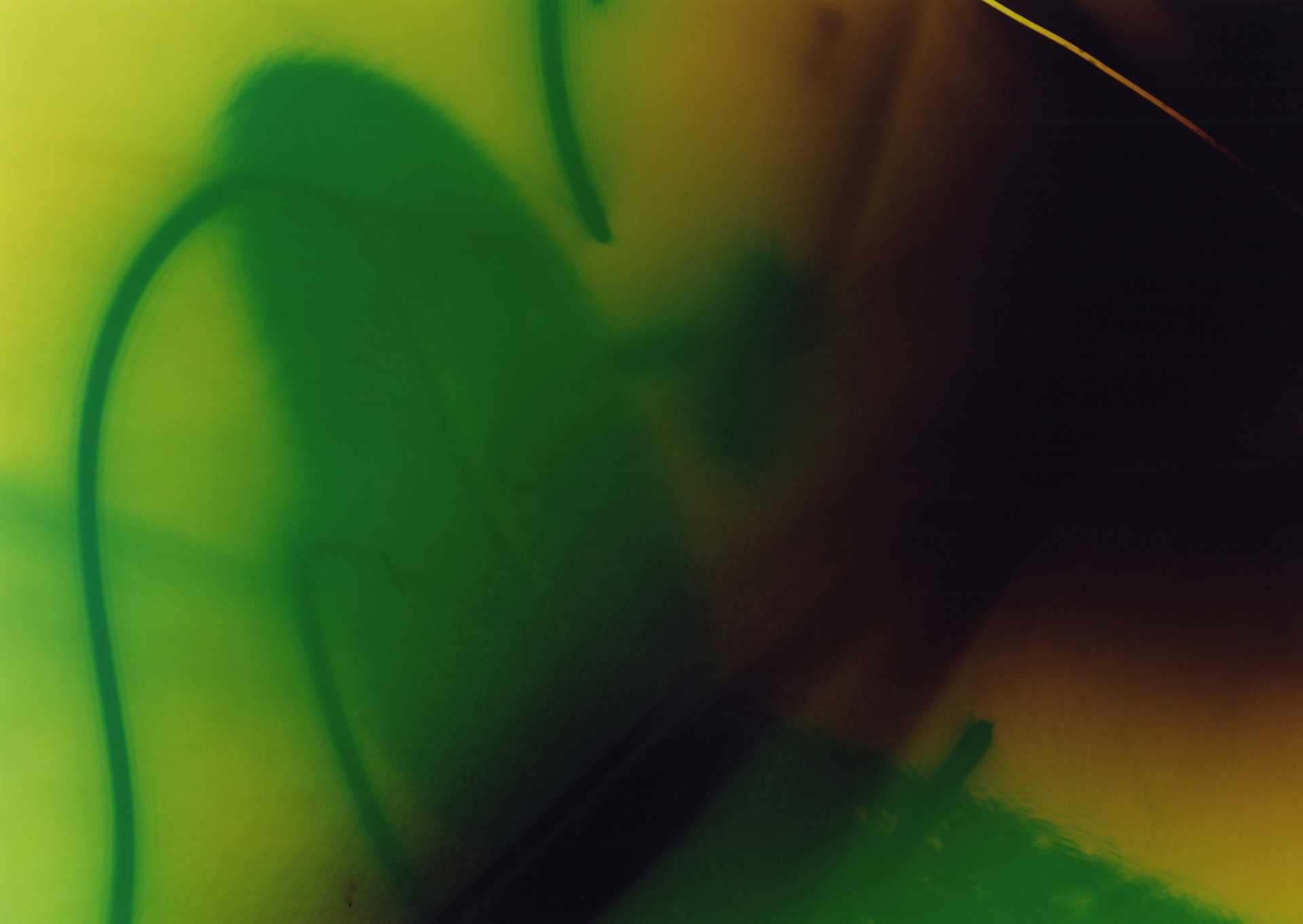 Green abstract photogram with flashes of black and yellow