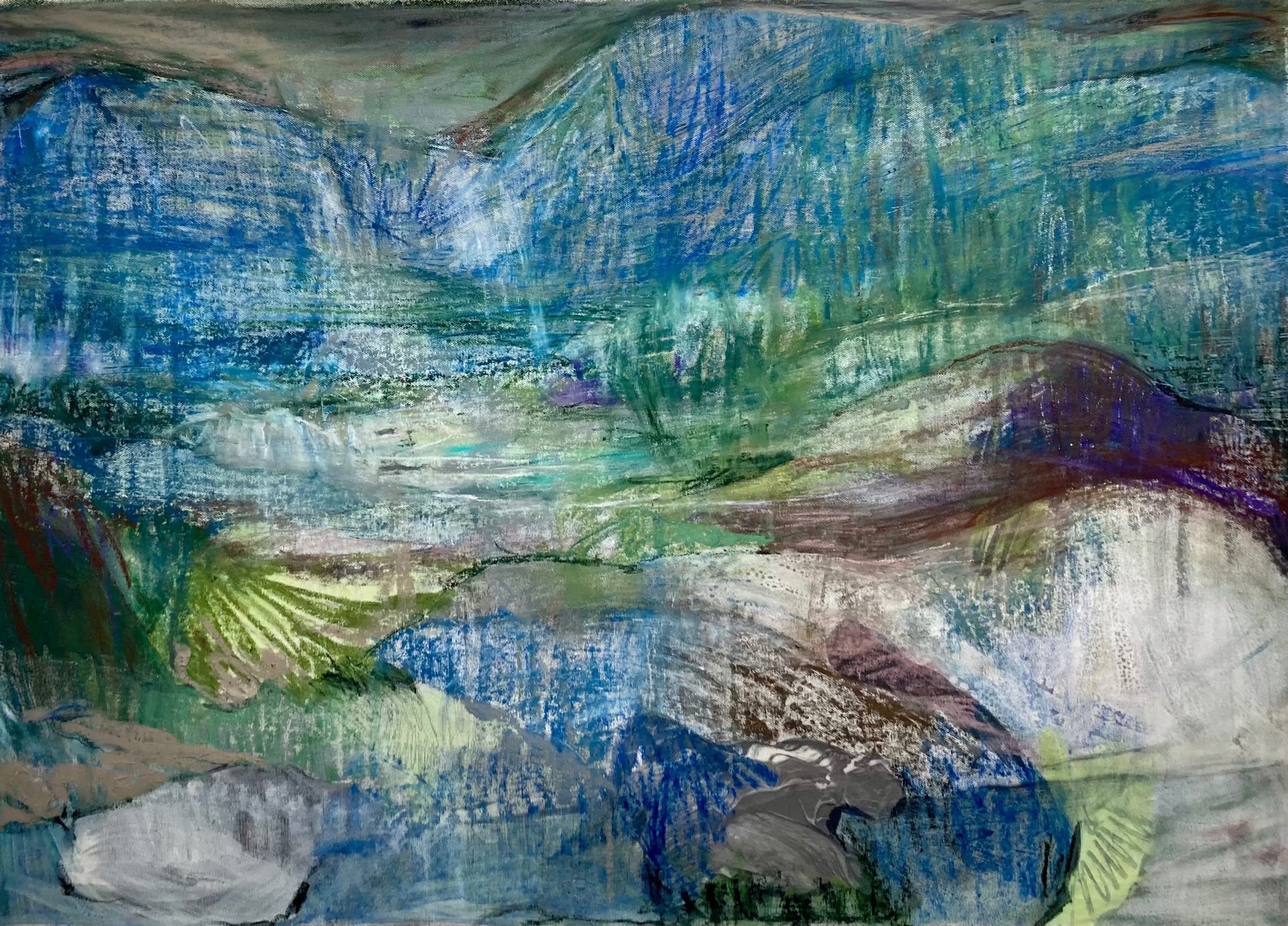 A rocky, mountainous landscape of blues and greens that appears to be dissolving