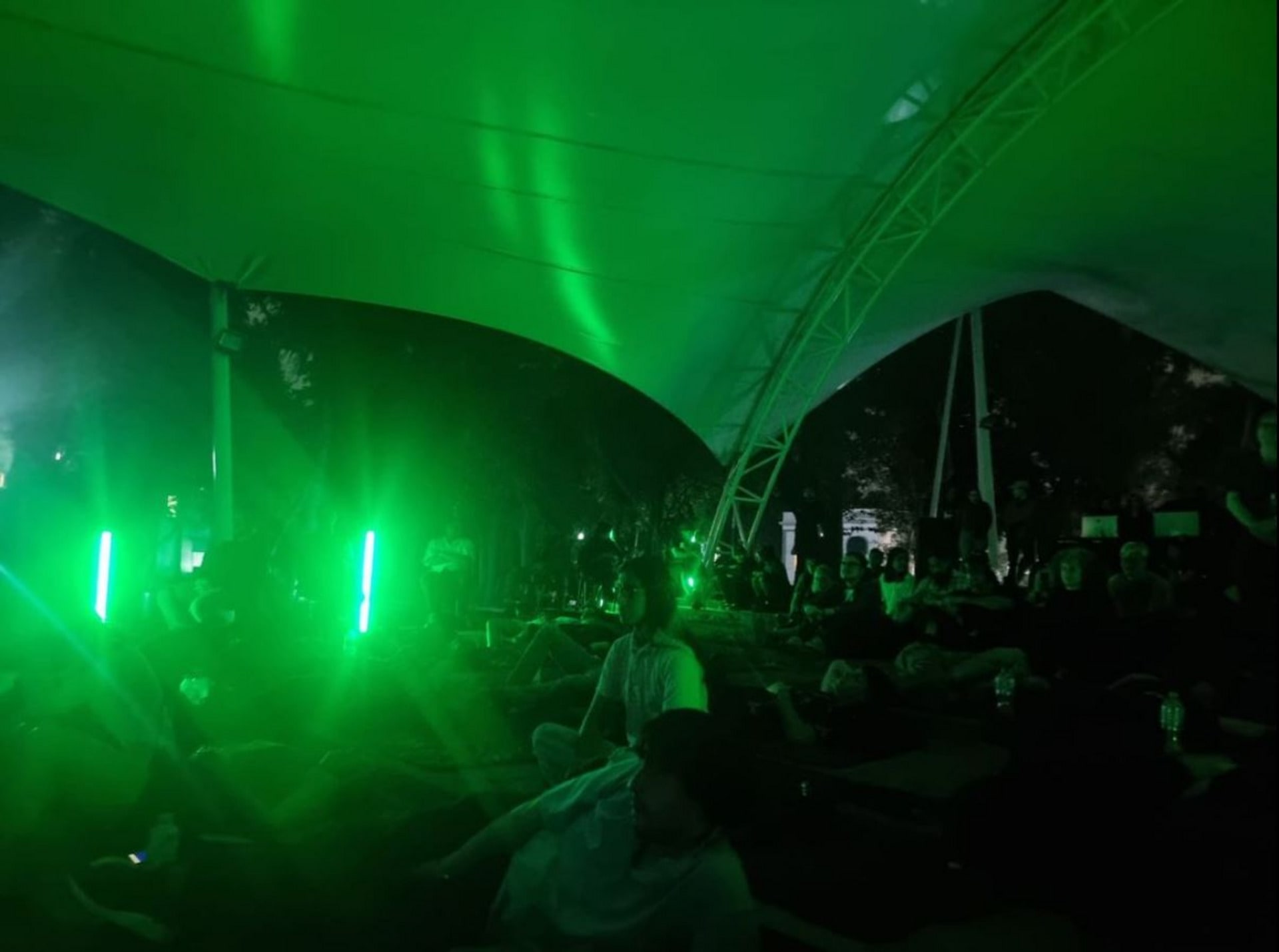 A photograph of an outdoor film screening in neon green