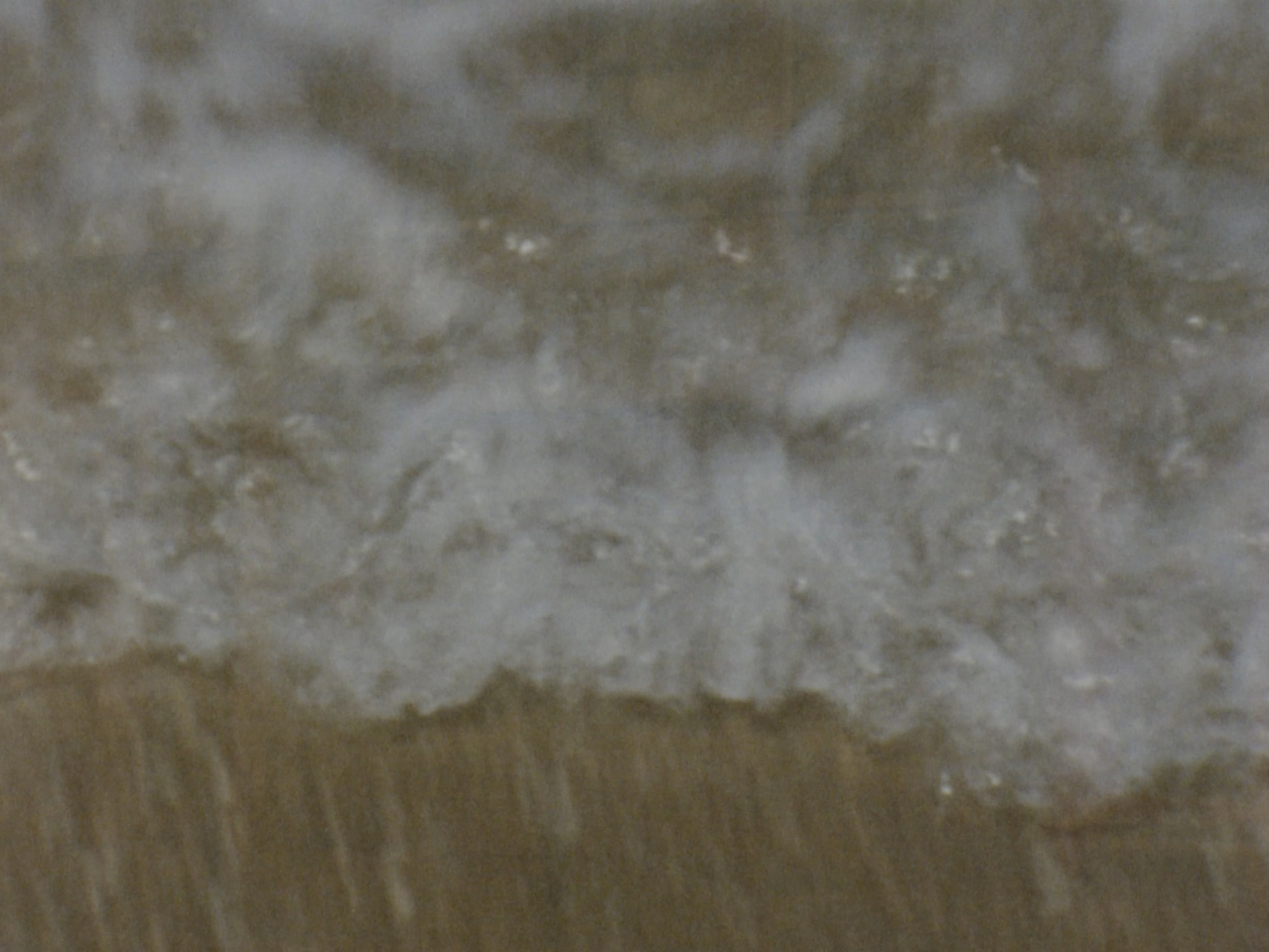 Still of waves hitting the sand shot on super 8