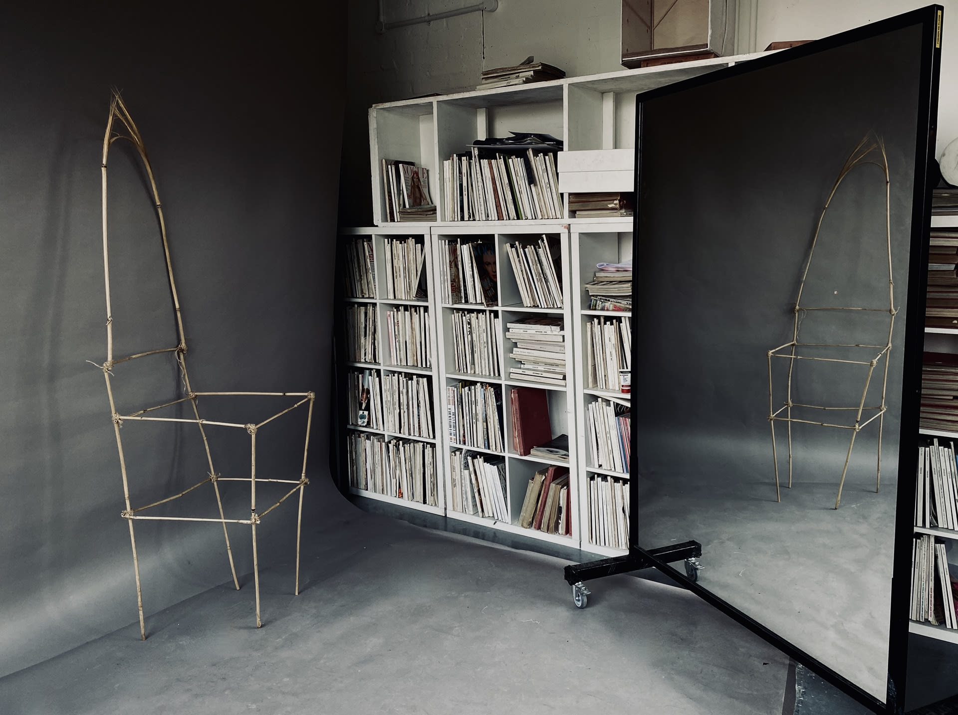 Chair sculpture reflecting onto a mirror. 