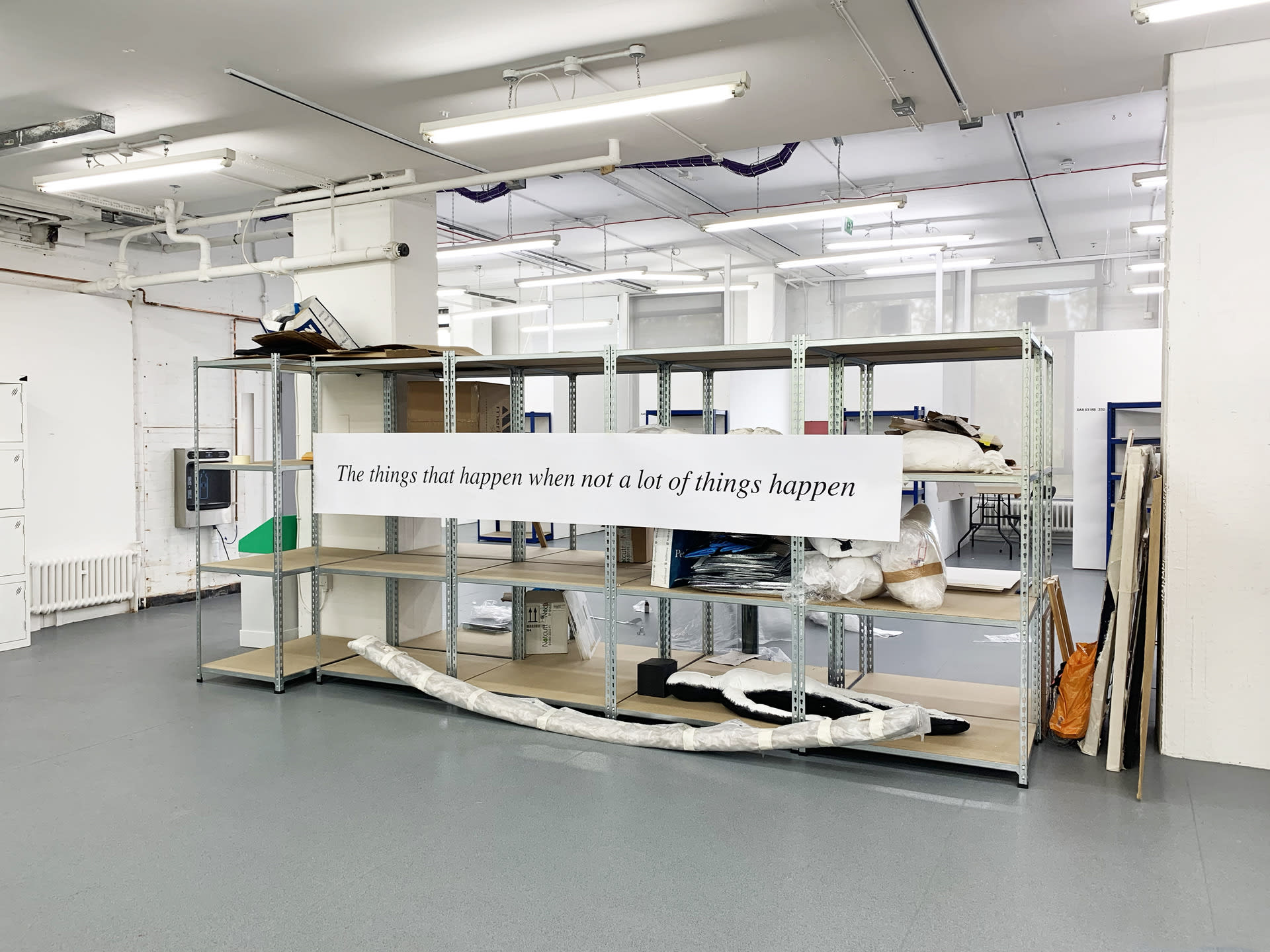 a large format print of a sentence, displayed on a shelving unit