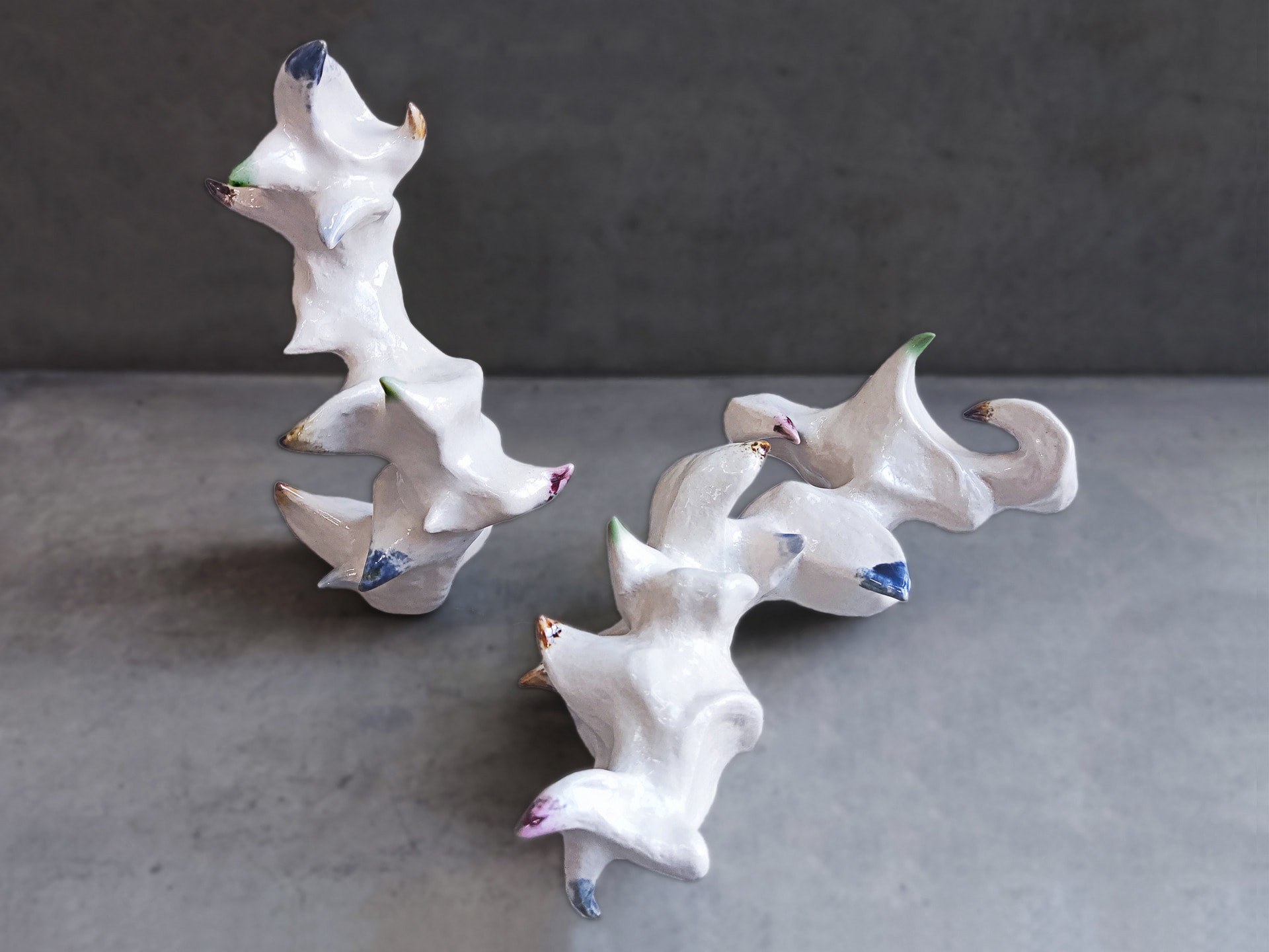 Two zoomorphic sculptures with color on their spines