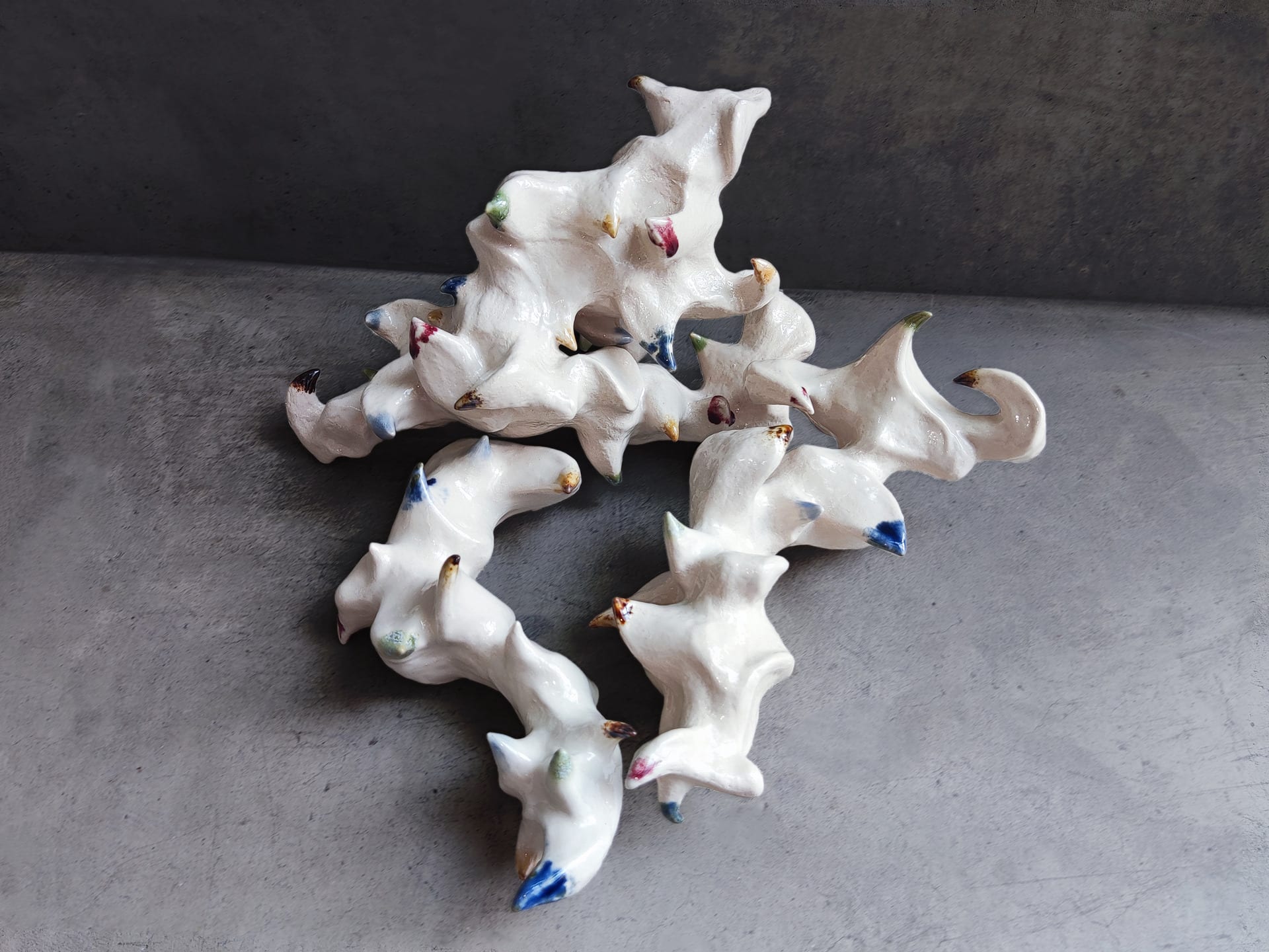 A group of zoomorphic sculptures with color on their spines