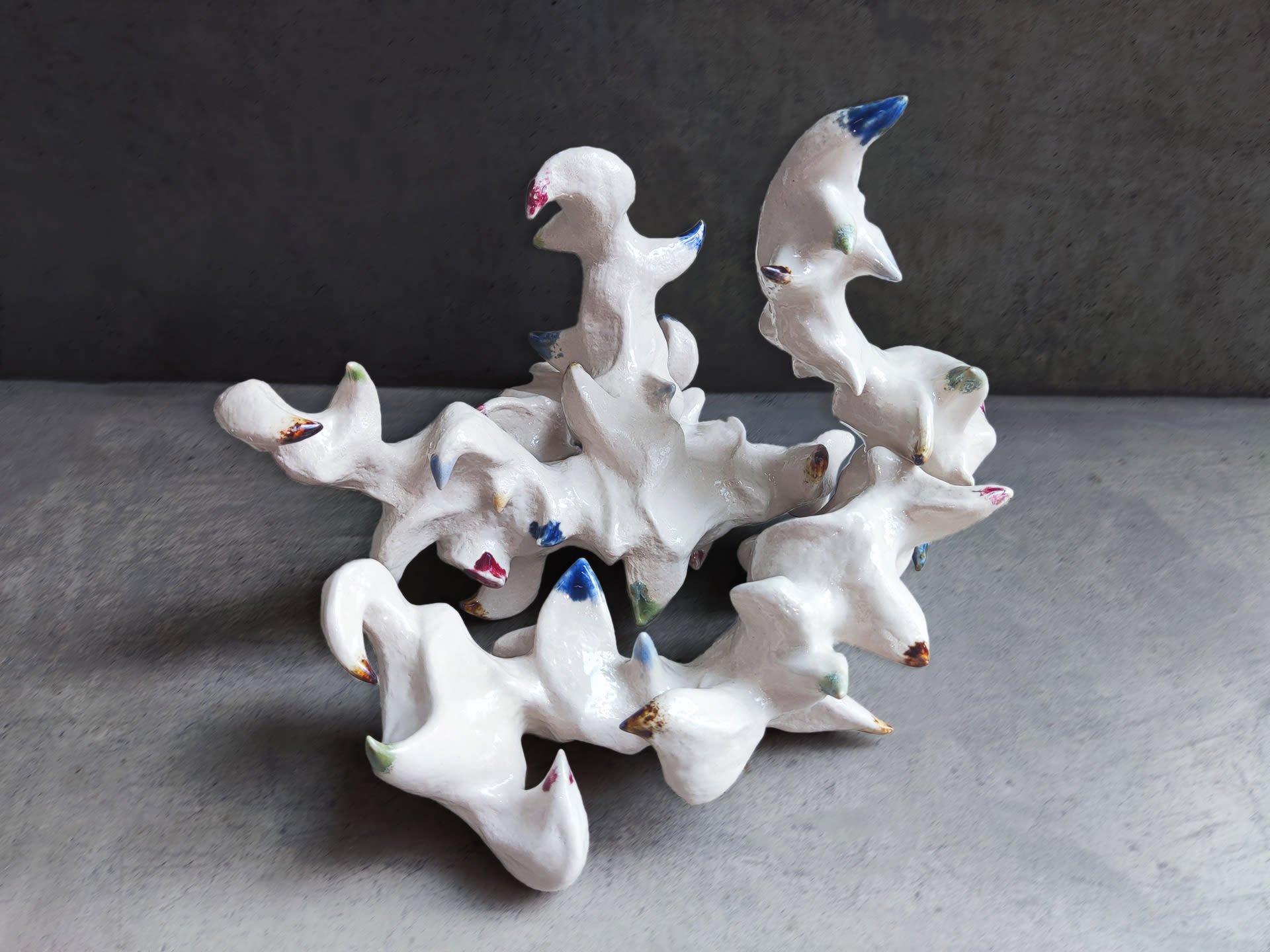 A group of zoomorphic sculptures with color on their spines