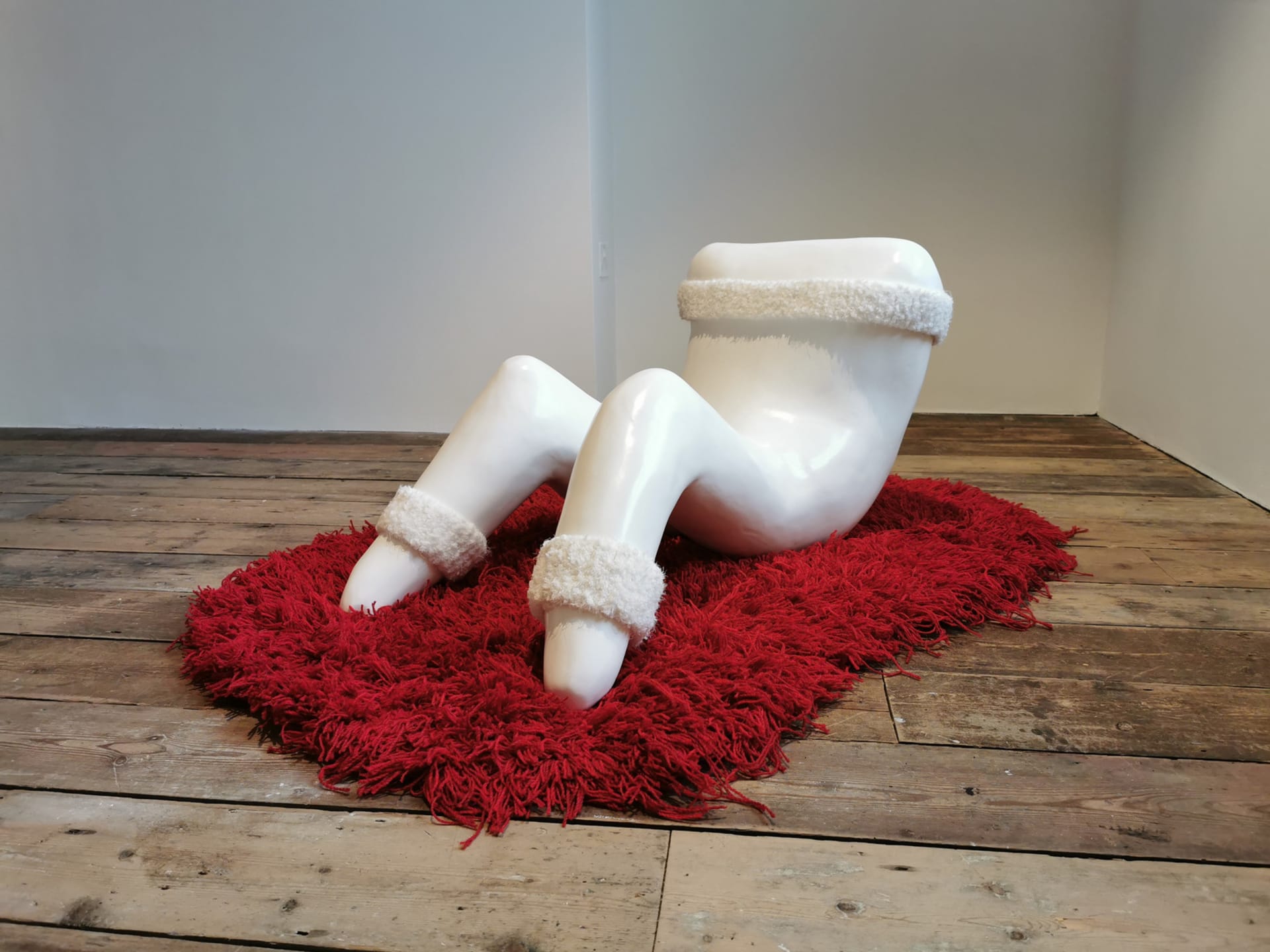 Materials: Jesmonite, Hand Tufted Carpet, Knitted headbands. 
An Anthropomorphic tooth performing sit-ups sits on a red red.