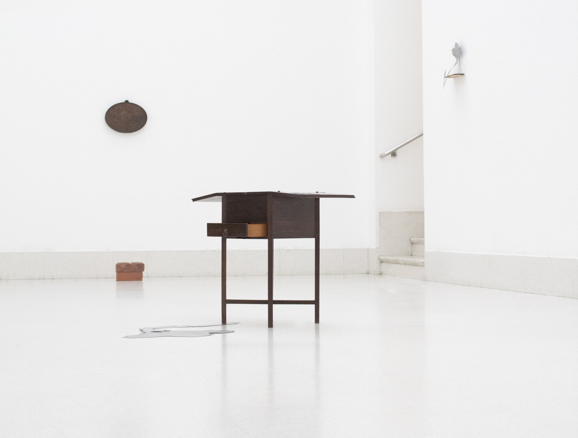 Installation of sculptural works, a found sewing table, laser cut geometric flowers and wooden pendant. 