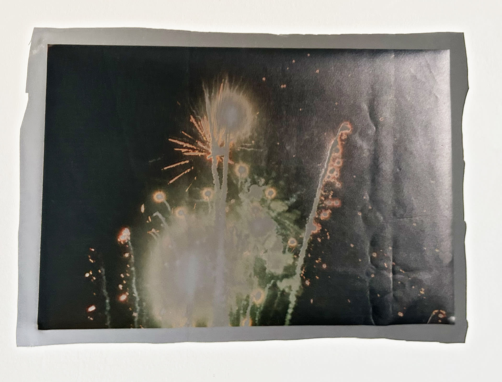 image of firework on reflective material with flash