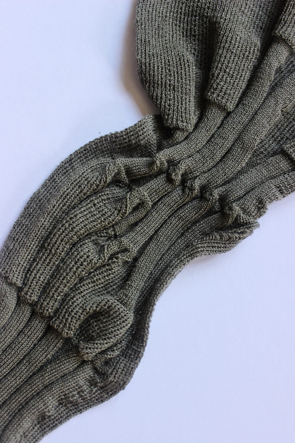 Deadstock wool swatch with twist detail. Khaki/deep green tone