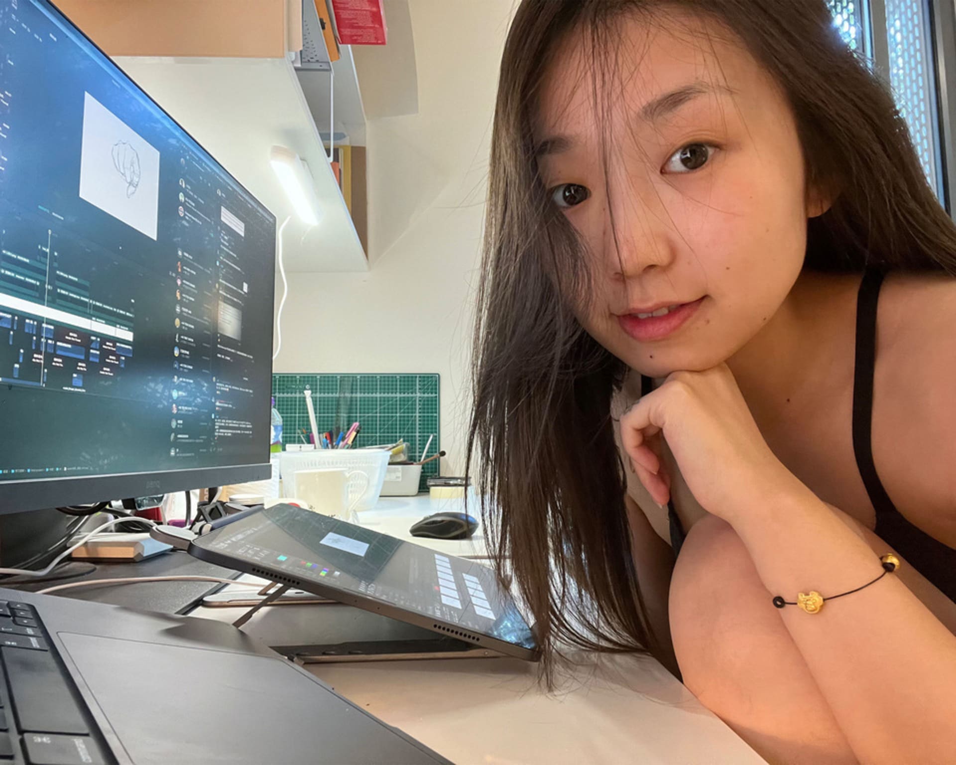 A photo of a girl who is doing animation in front of the desktop