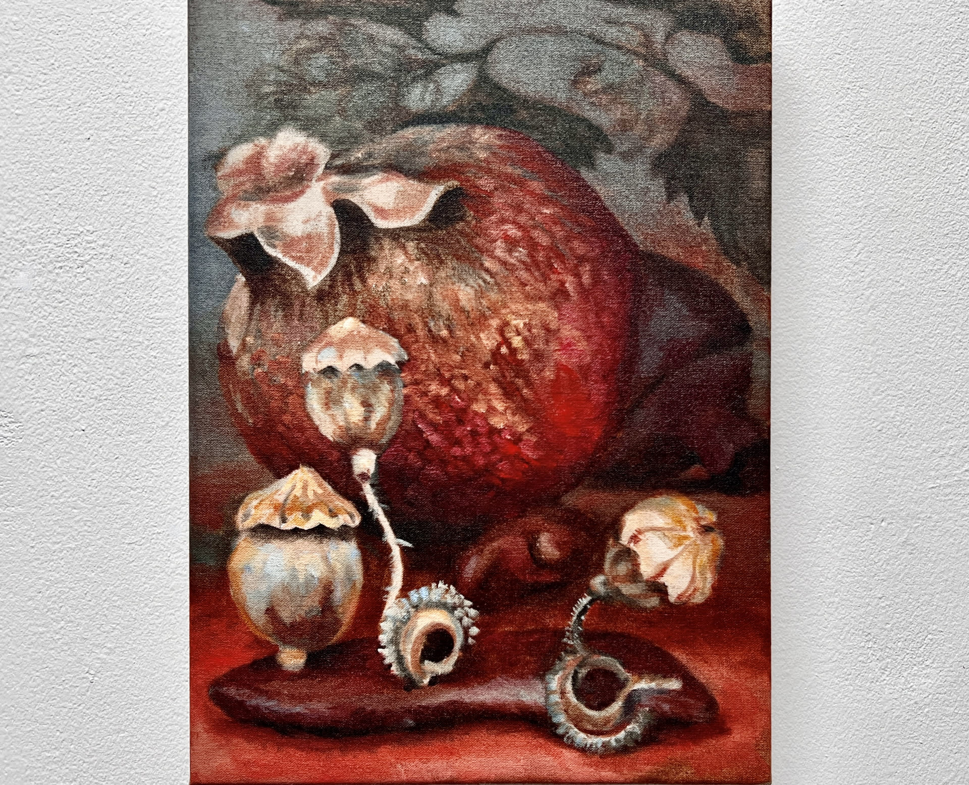 still life painting a pomegranate, poppy pods and nettle, horizontal view