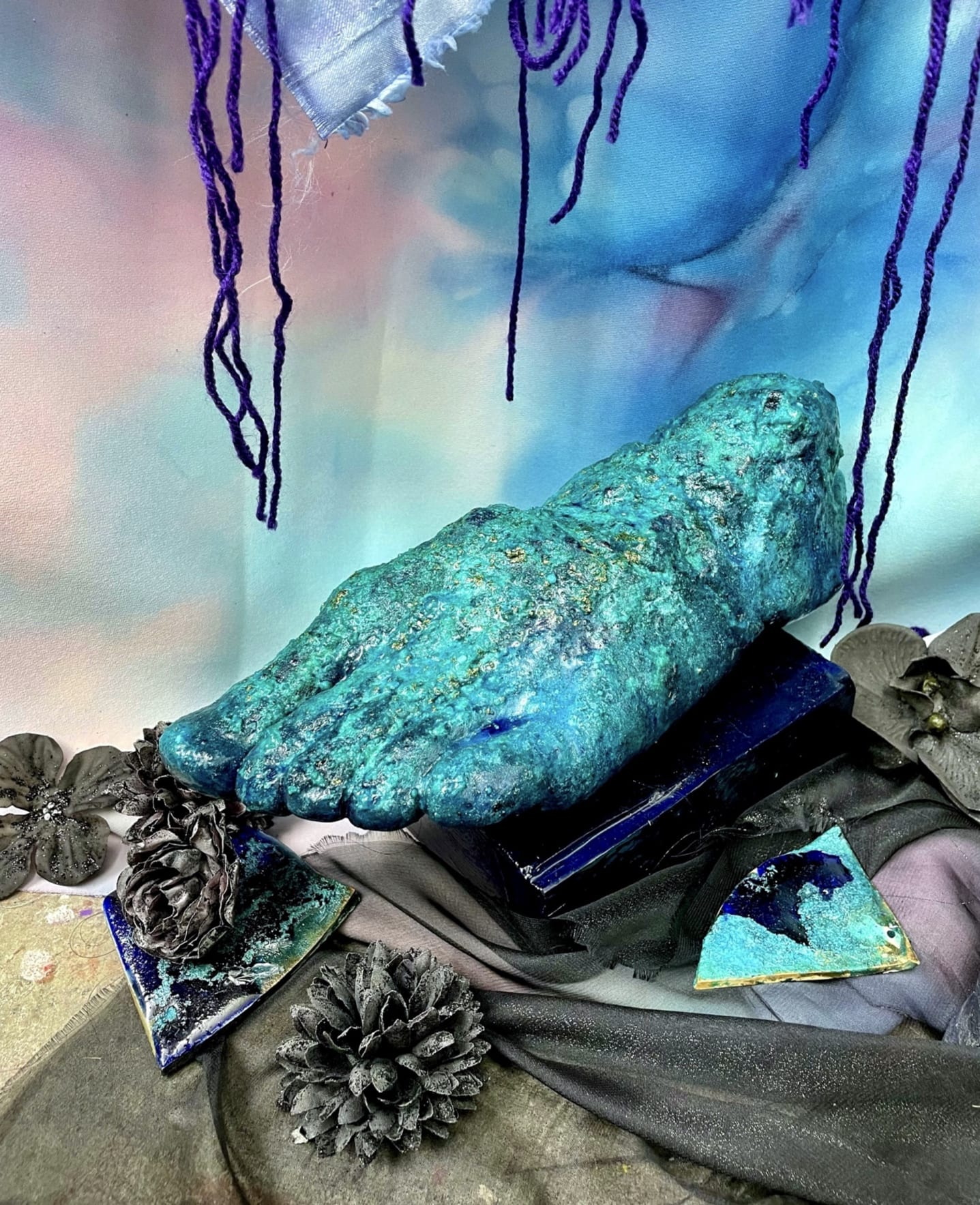 Foot cast in crystals and blue pigments and patina on a wooden base