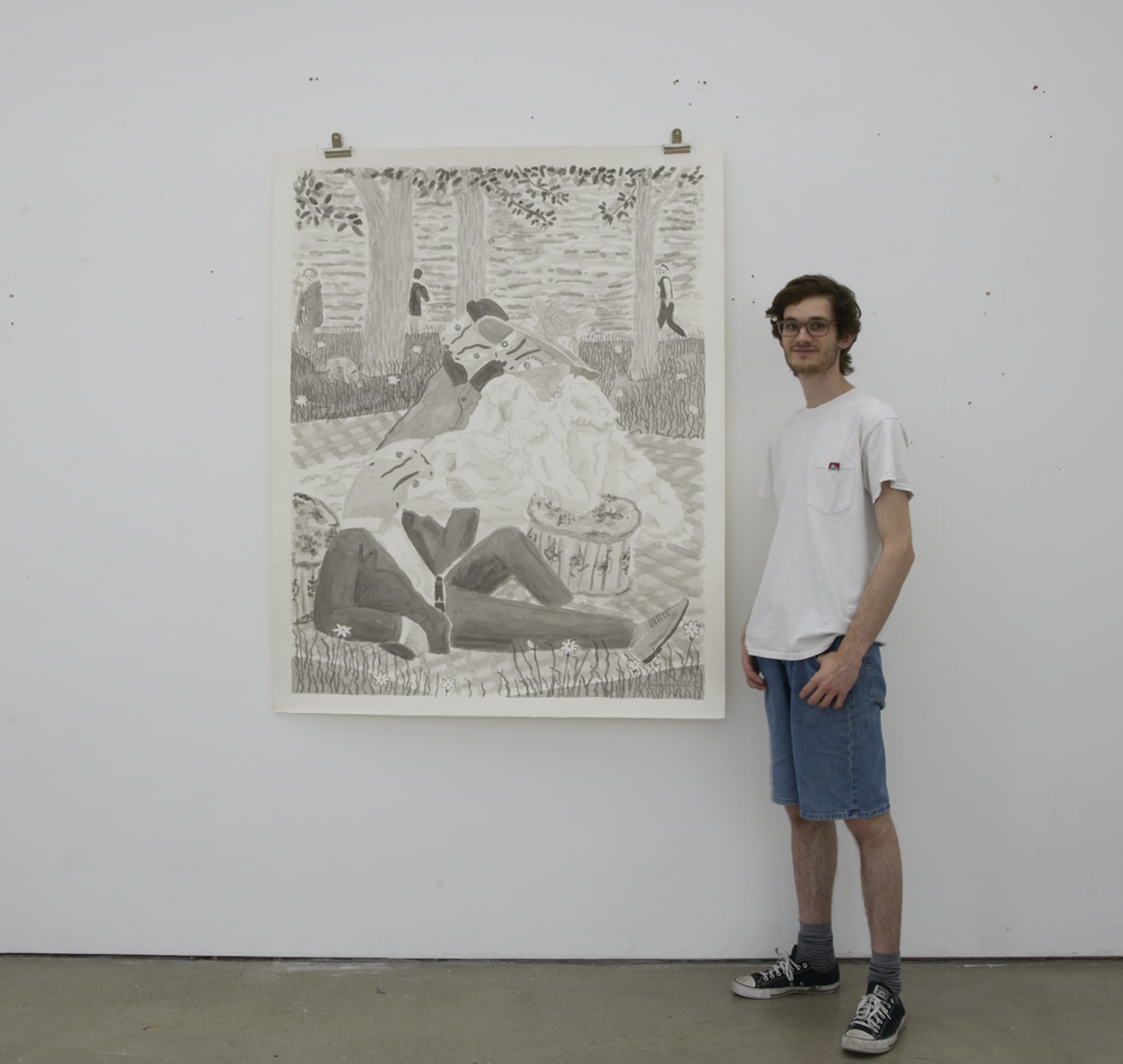 Artist next to large paper work 