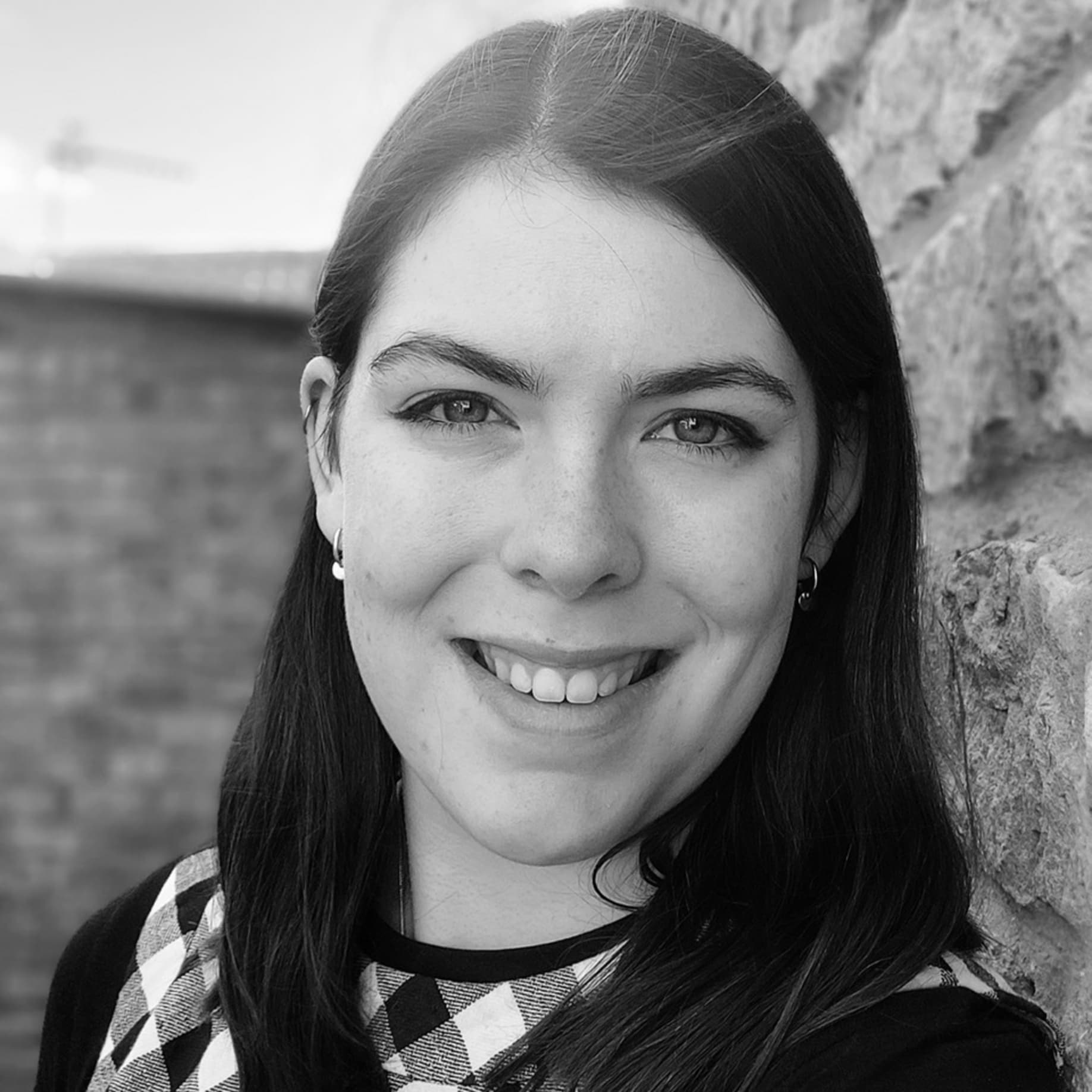 A black and white image of a smiling woman