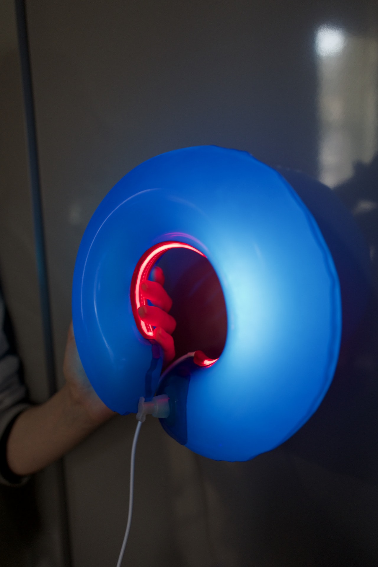 Ring blue latex lamp hold in hand