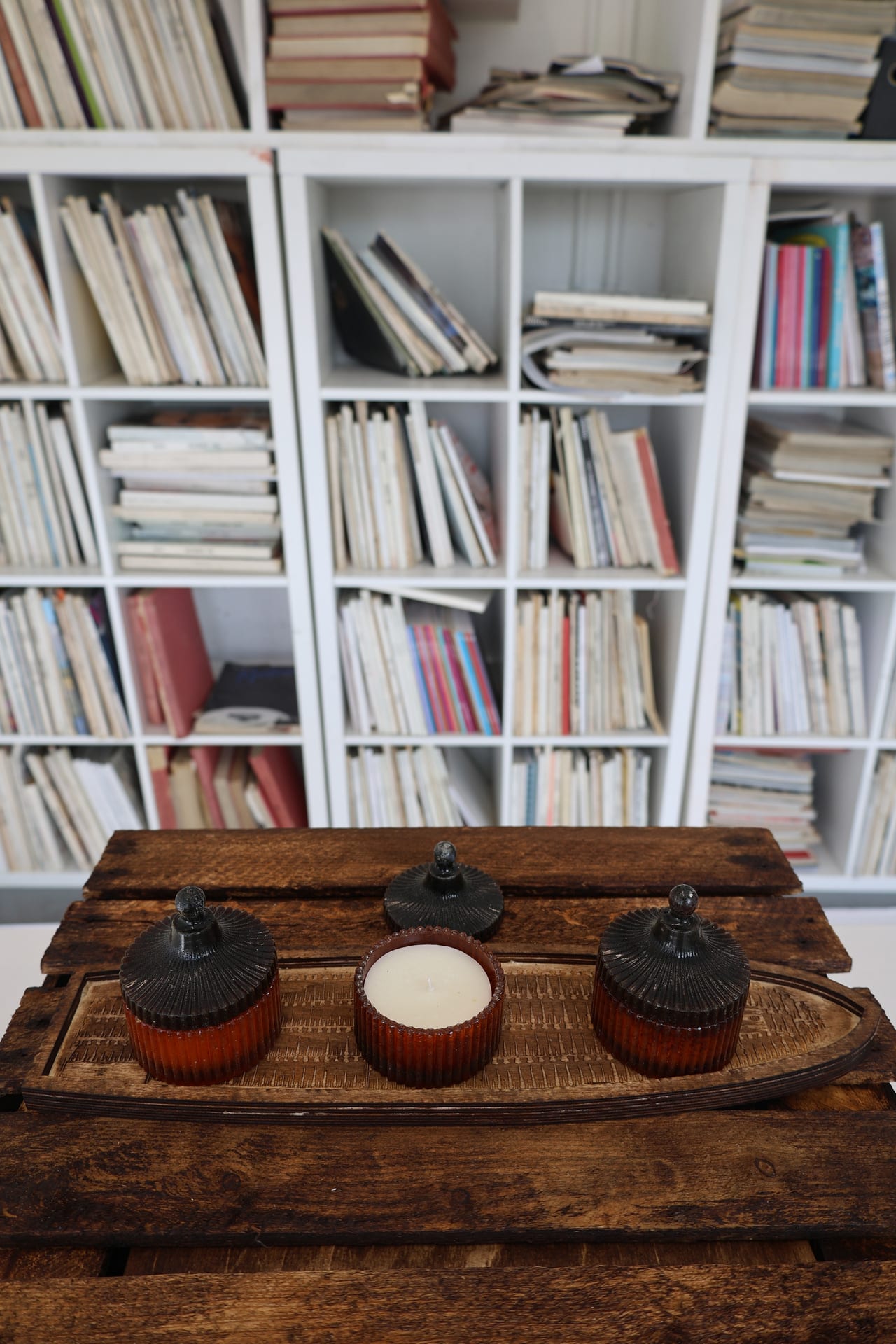 a wooden box with three candles on top.