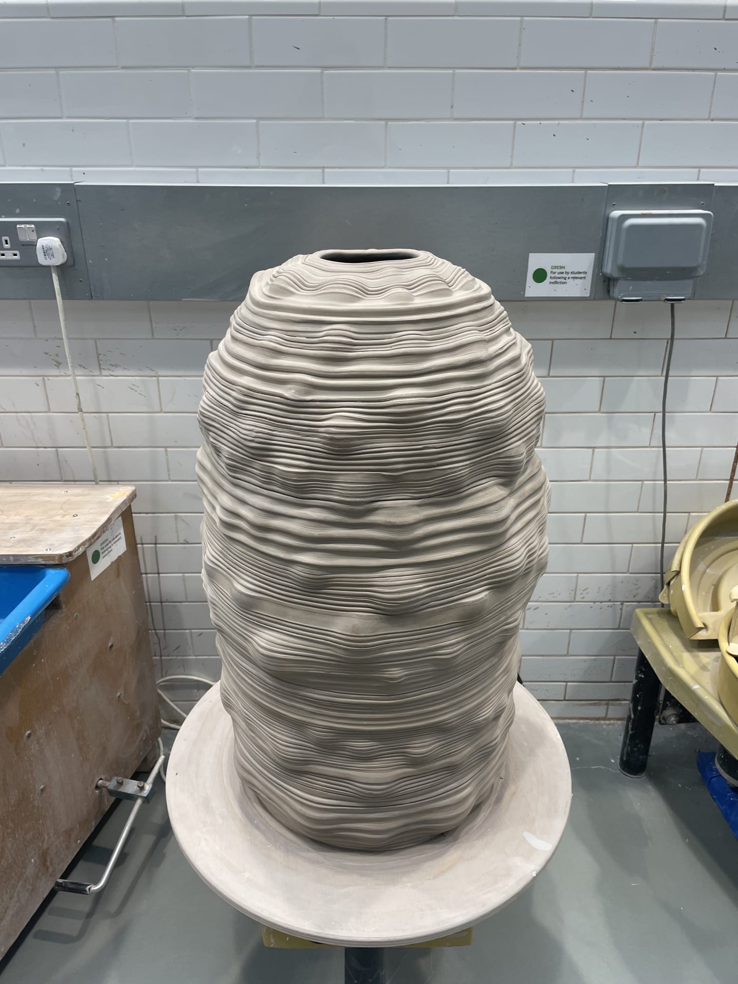 a large hive like form on the potters wheel.