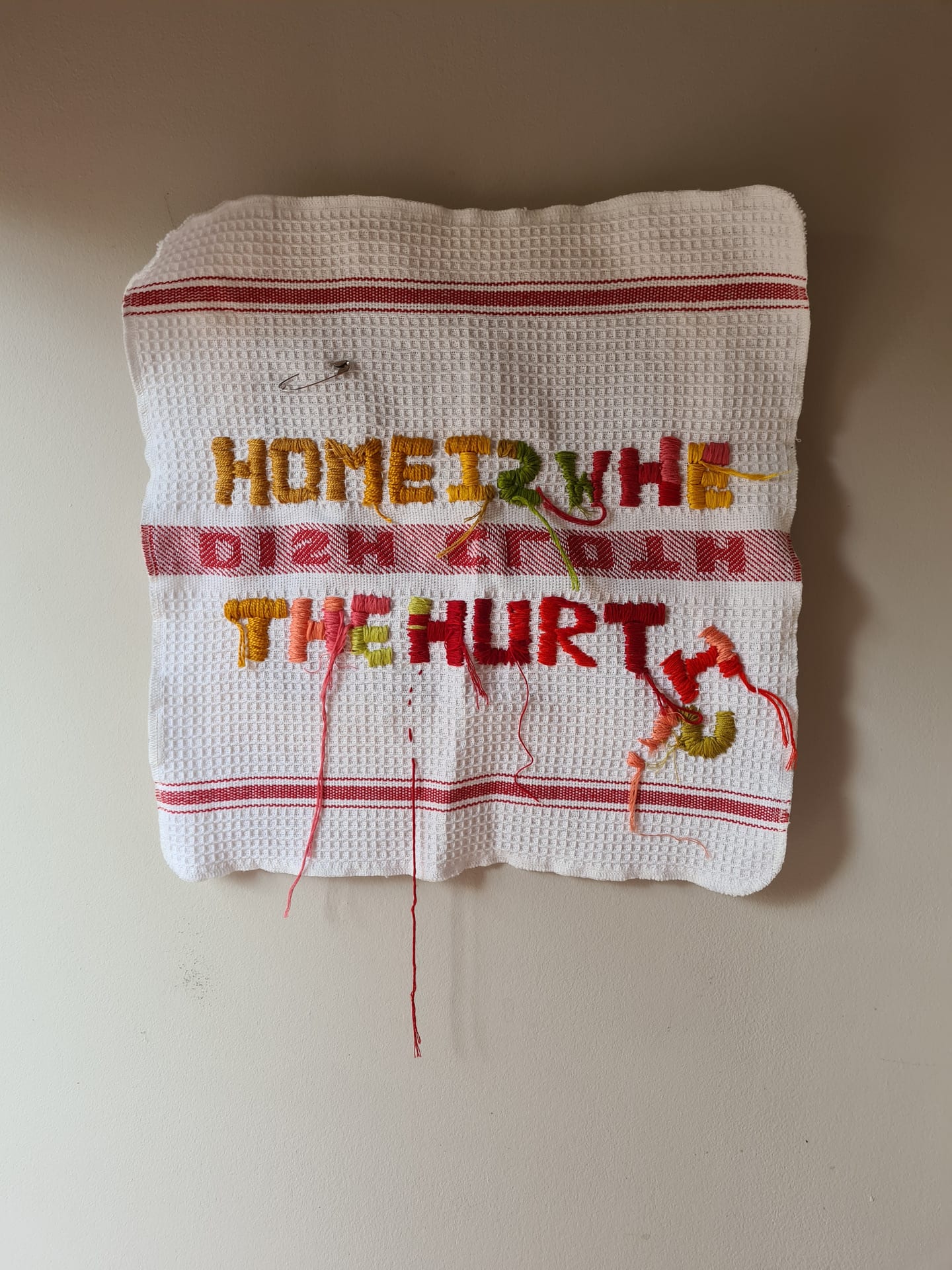 dish cloth embroidered with Home is where the hurt is in style of sampler 