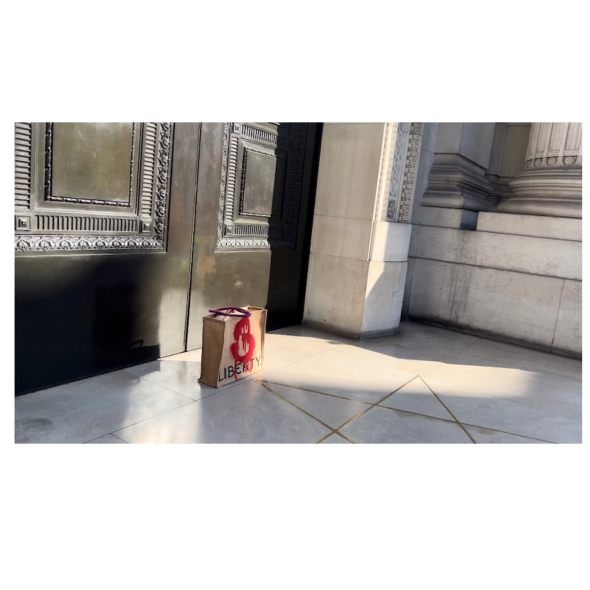 Carrier bag, on the ground, by pentagram tip. By doors and pillars.