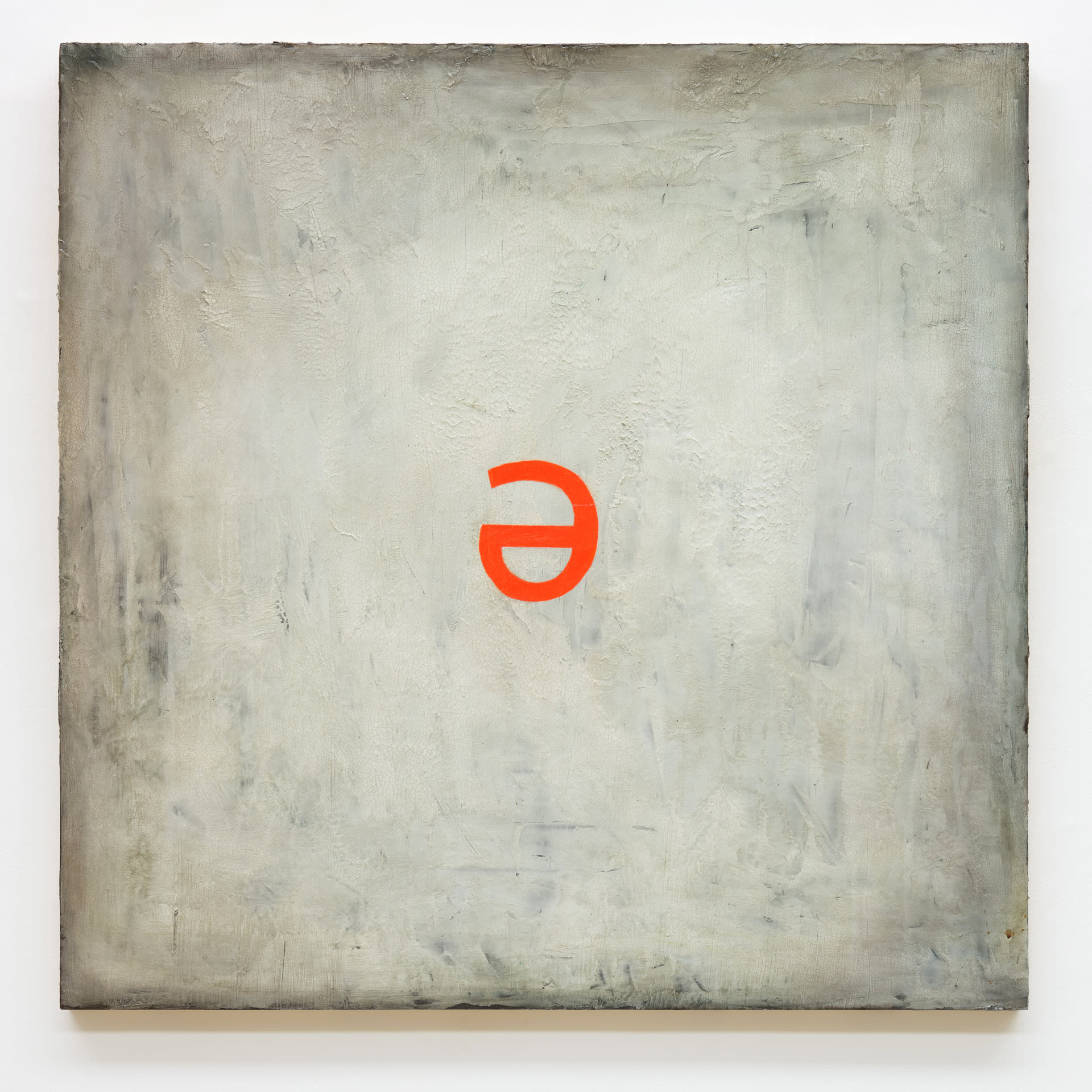 A neon orange schwa floats in the centre of a beige acrylic ground.