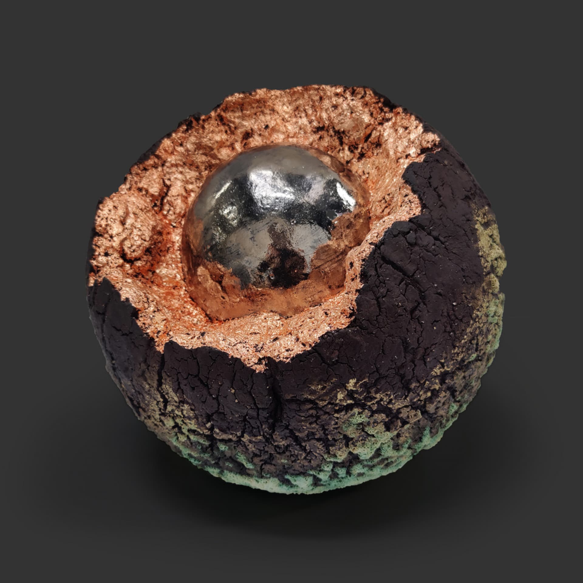 An image of ceramic sculpture by Chloe Lennon with metal copper leaf and volcanic glazes representing nature and industry. 