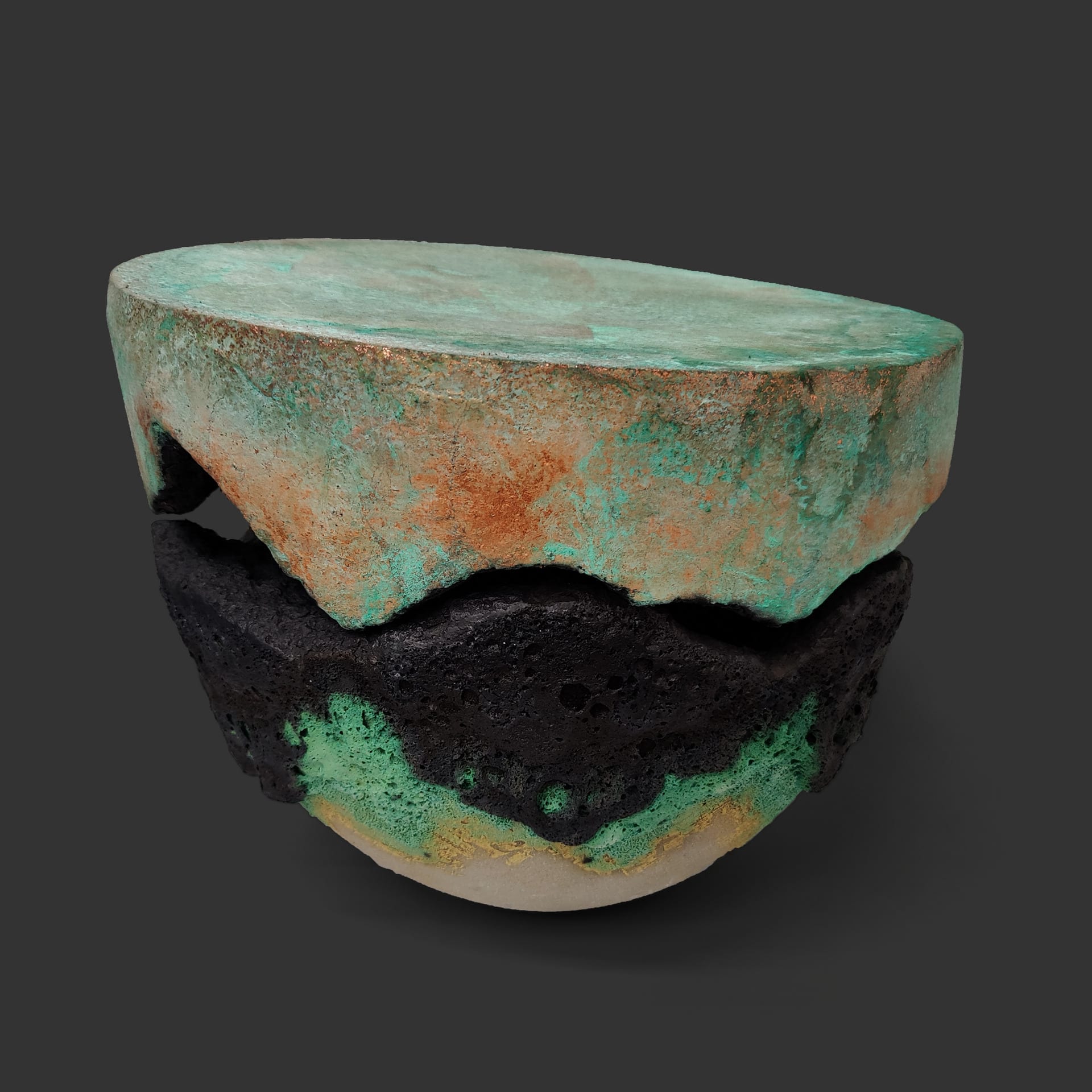 An image of ceramic sculpture by Chloe Lennon with metal copper leaf and volcanic glazes representing nature and industry. 