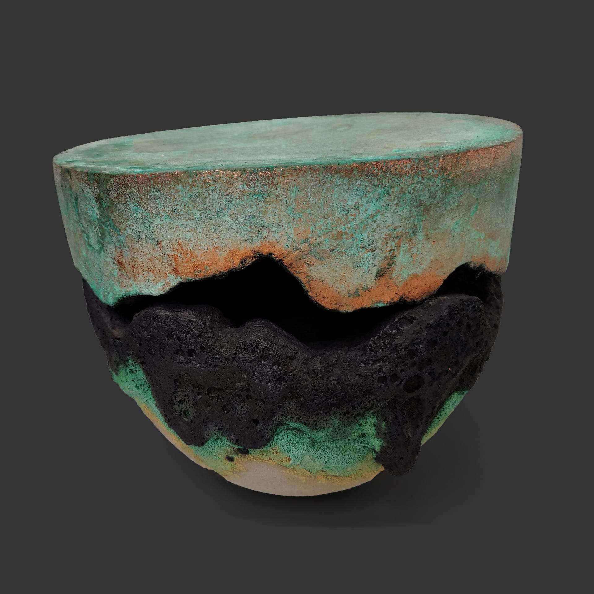 An image of ceramic sculpture by Chloe Lennon with metal copper leaf and volcanic glazes representing nature and industry. 