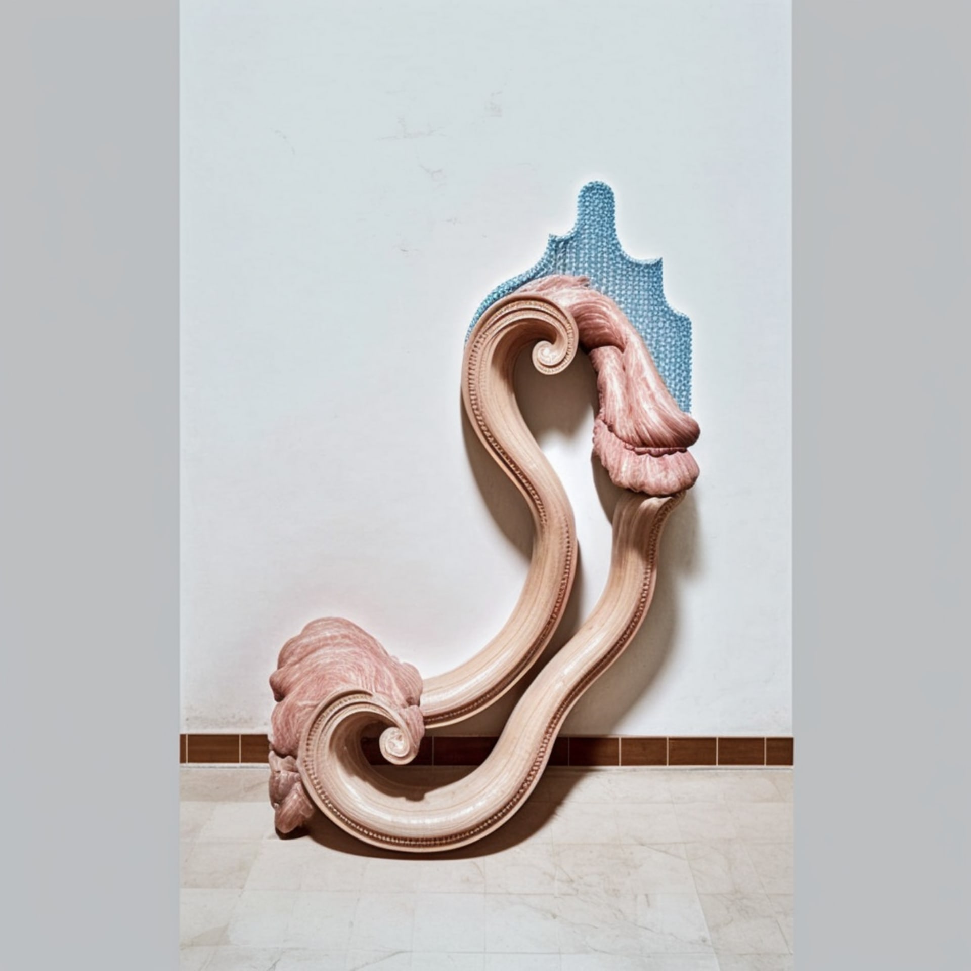 This image is a sculpture with a wavy shape and is predominantly pink and beige in color.