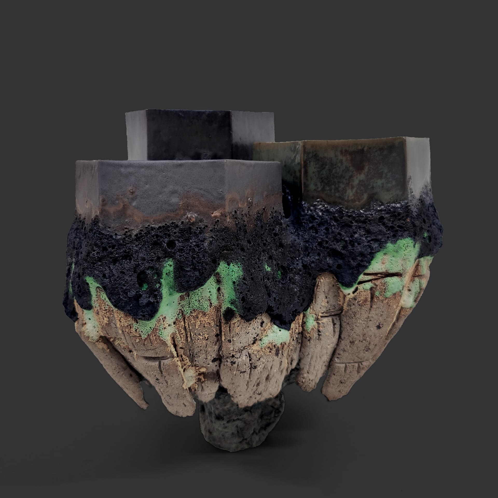 An image of ceramic sculpture by Chloe Lennon with metal copper leaf and volcanic glazes representing nature and industry. 