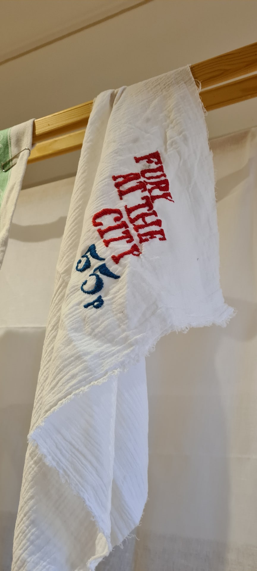 baby muslin with the word displayed on a washing airer 