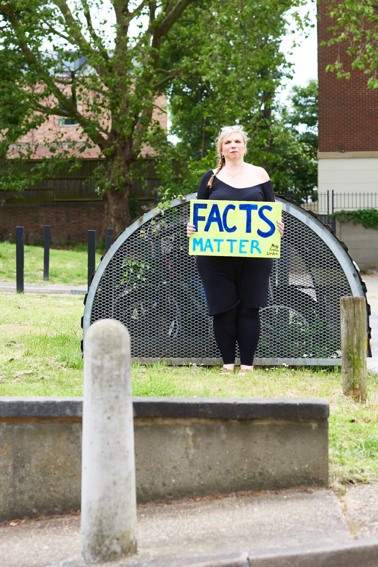 Mary Amelia London stands holding a sign saying: 'Facts matter'