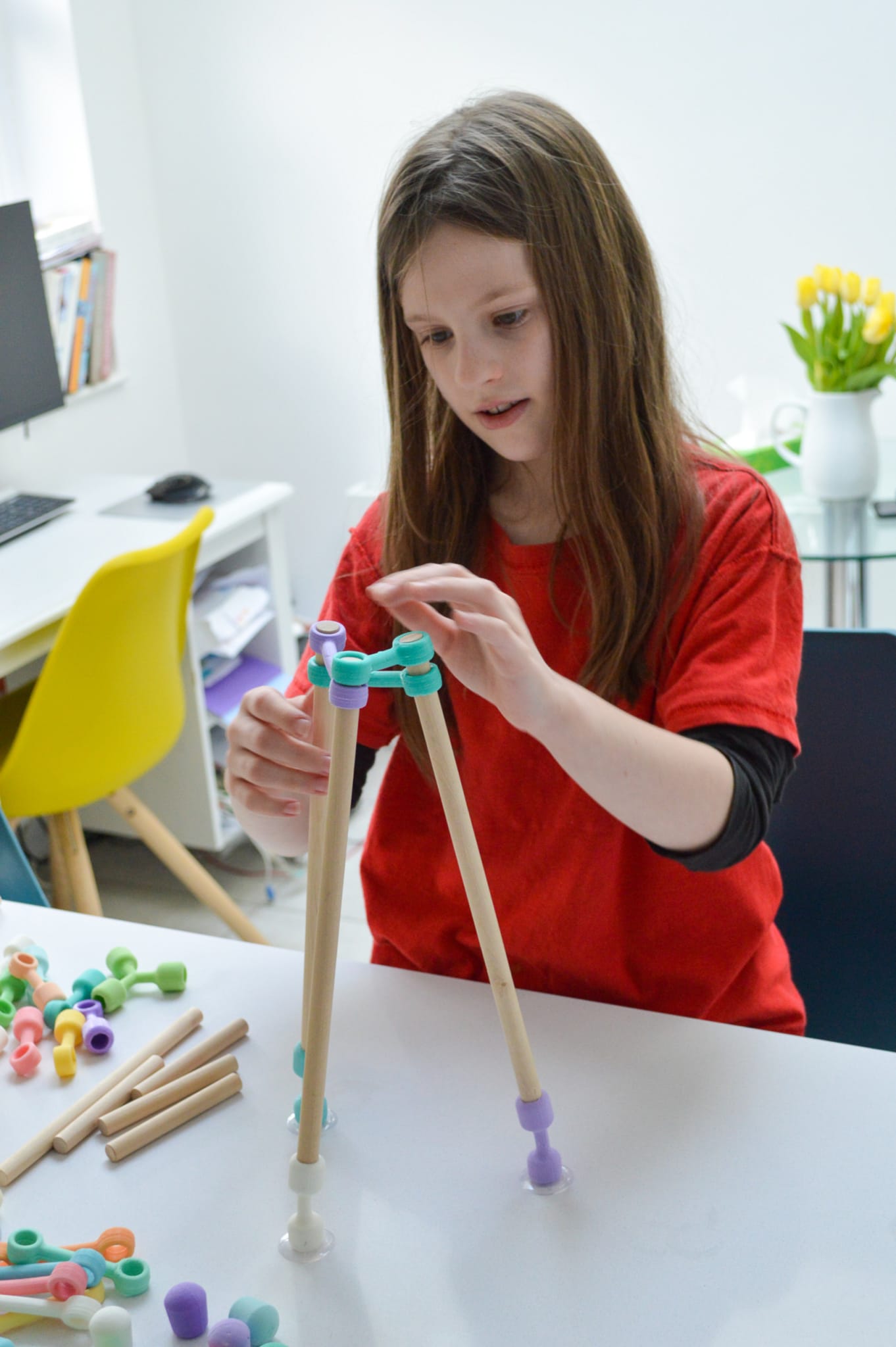 A girl building a structure.