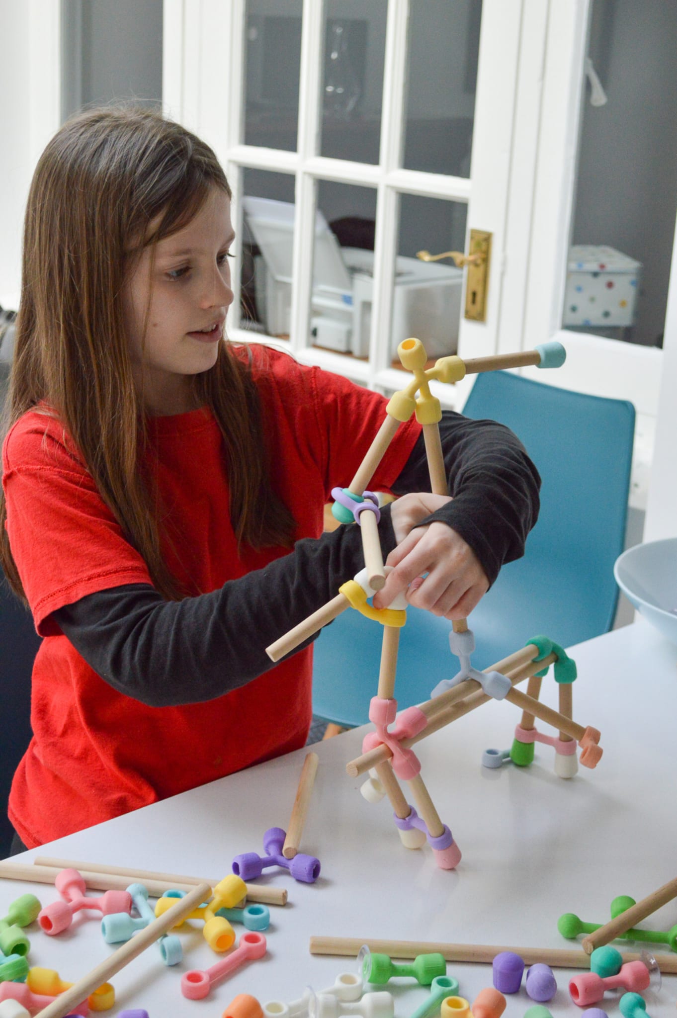 A girl building a horse and rider.