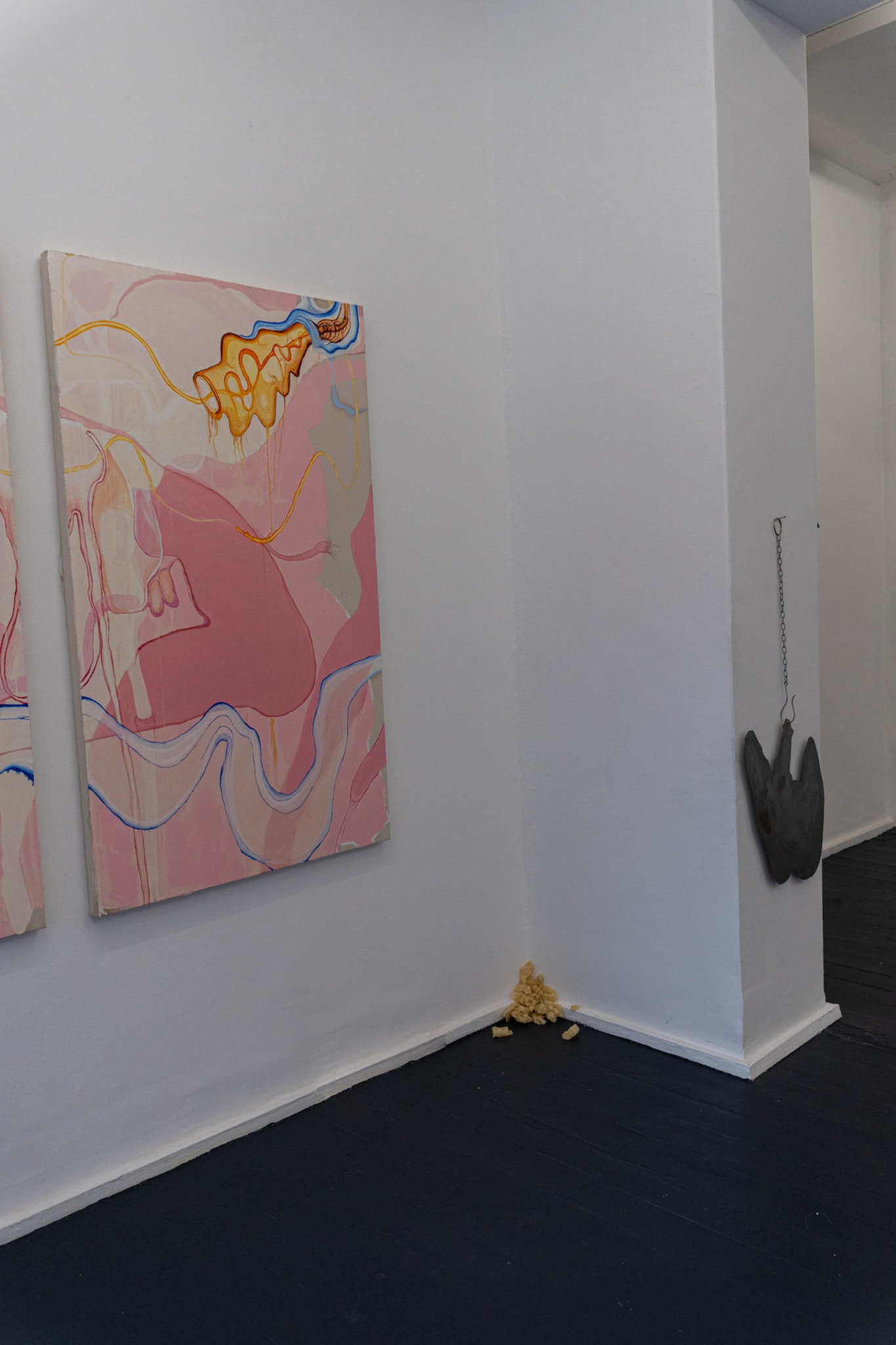 Installation Shot; painting and metal flats sculpture hung on wall by chain 