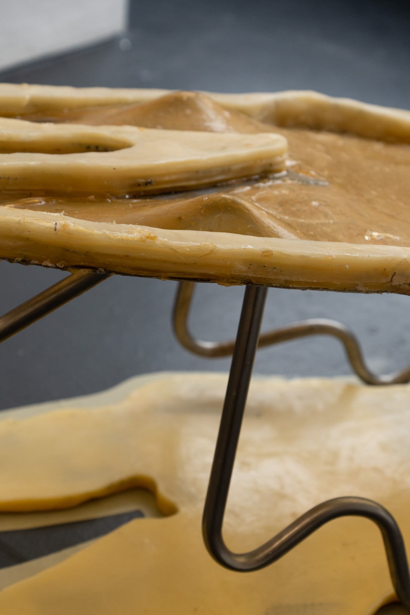 Close up image of the Abstract figure of a bod laying on a metal structure