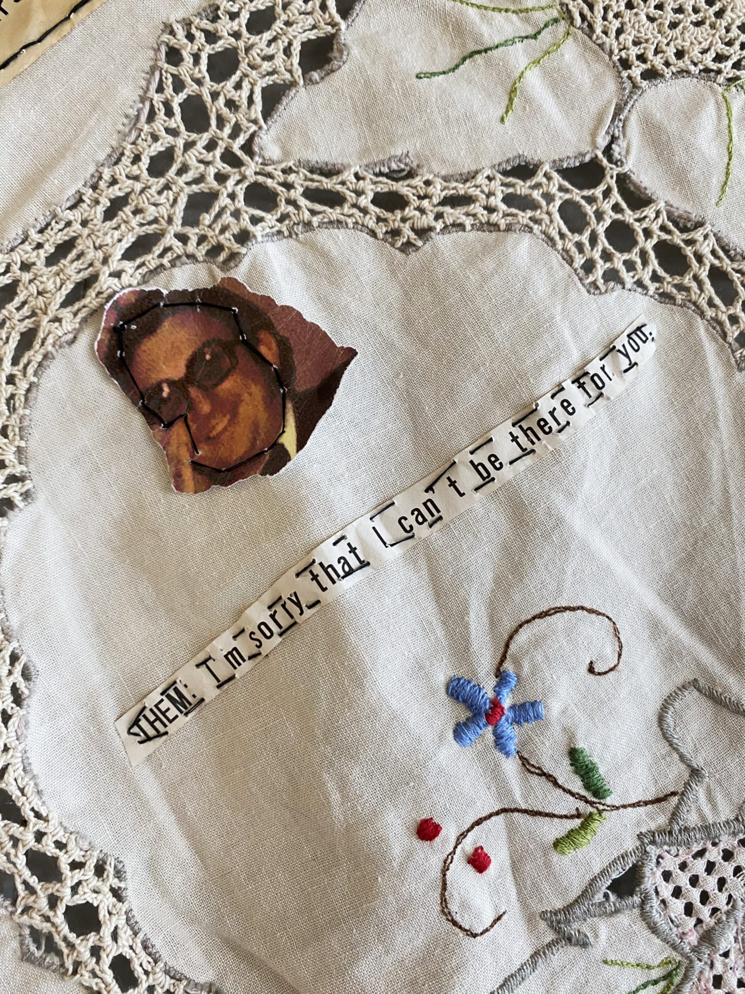 Detail of tablecloth, man's face and text "Them: I'm sorry that I can't be there for you"