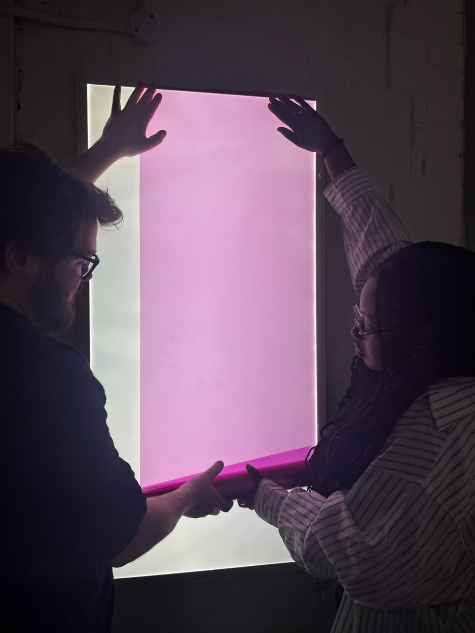 Qyinkan and I preparing the pink film for our hallway installation. 