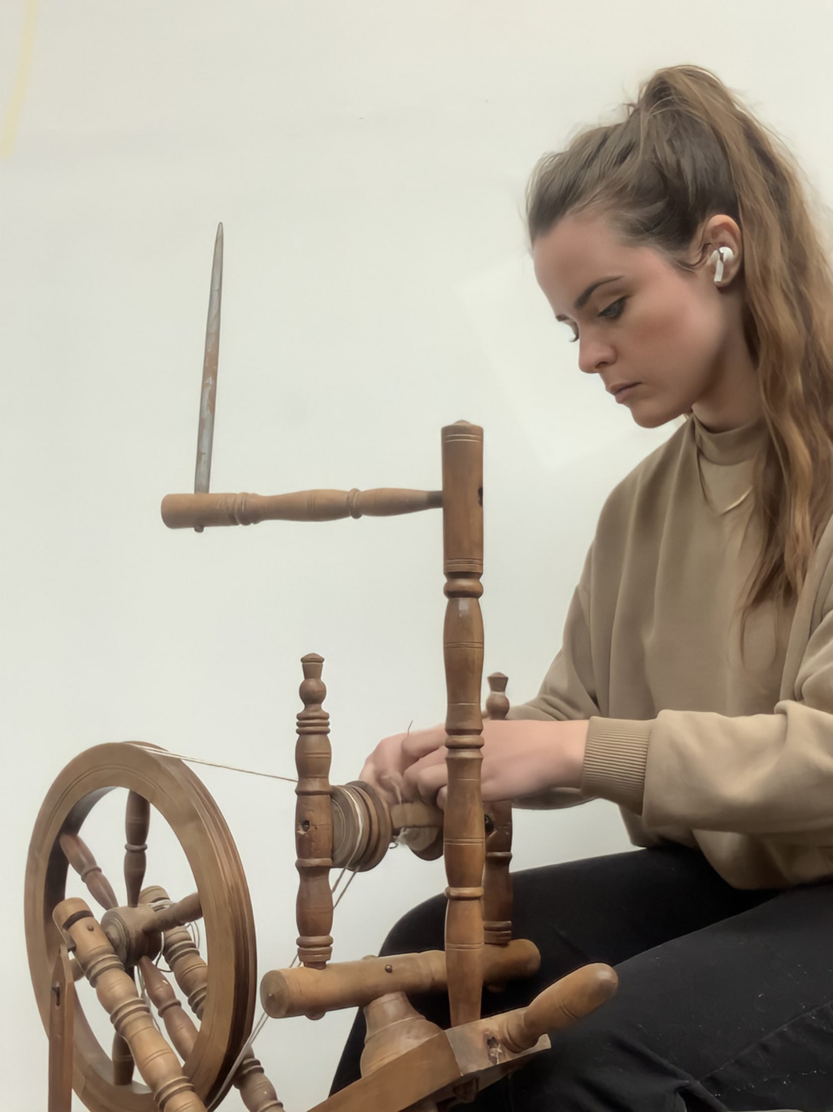 Myself on a spinning wheel spinning the wool and gold together. 