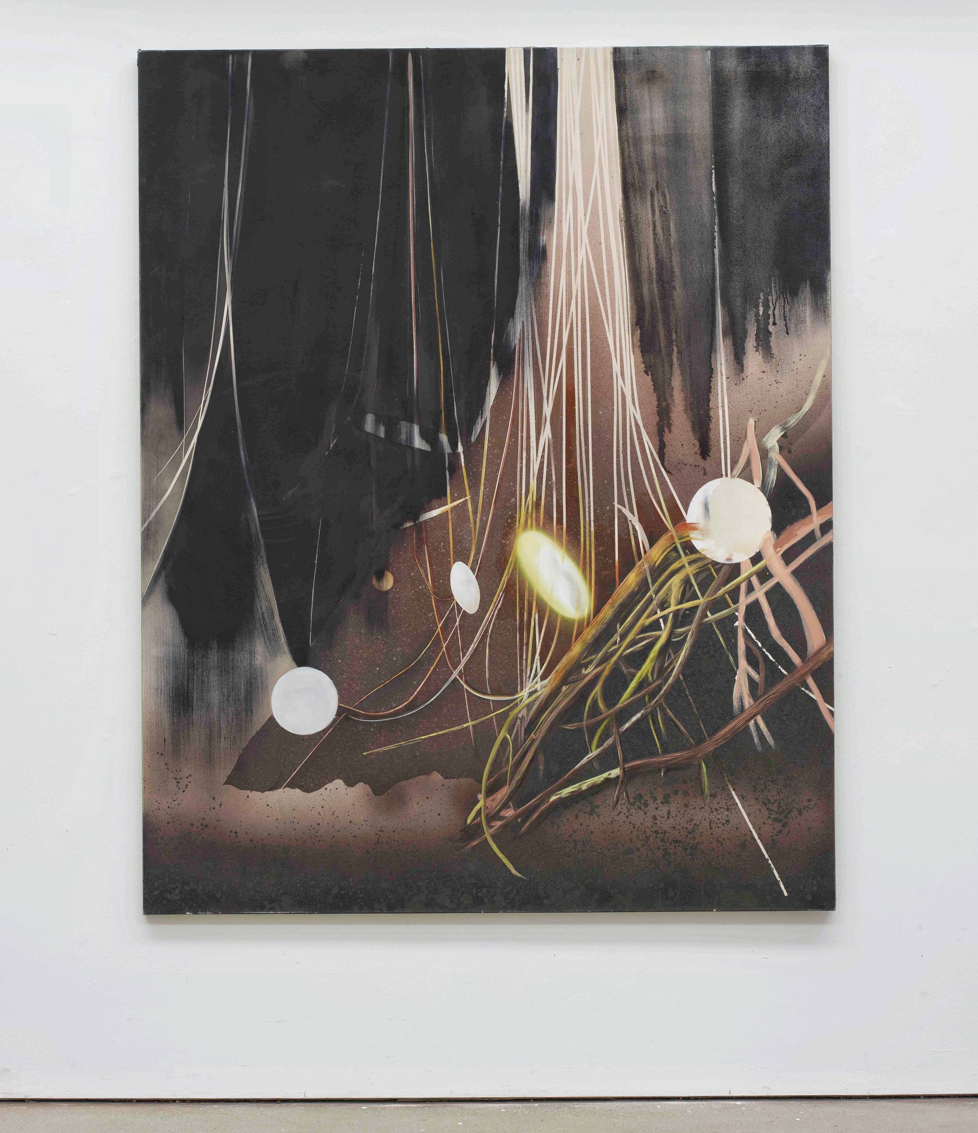 a large canvas of dark brown and black painted lines , glowing ovals and branches