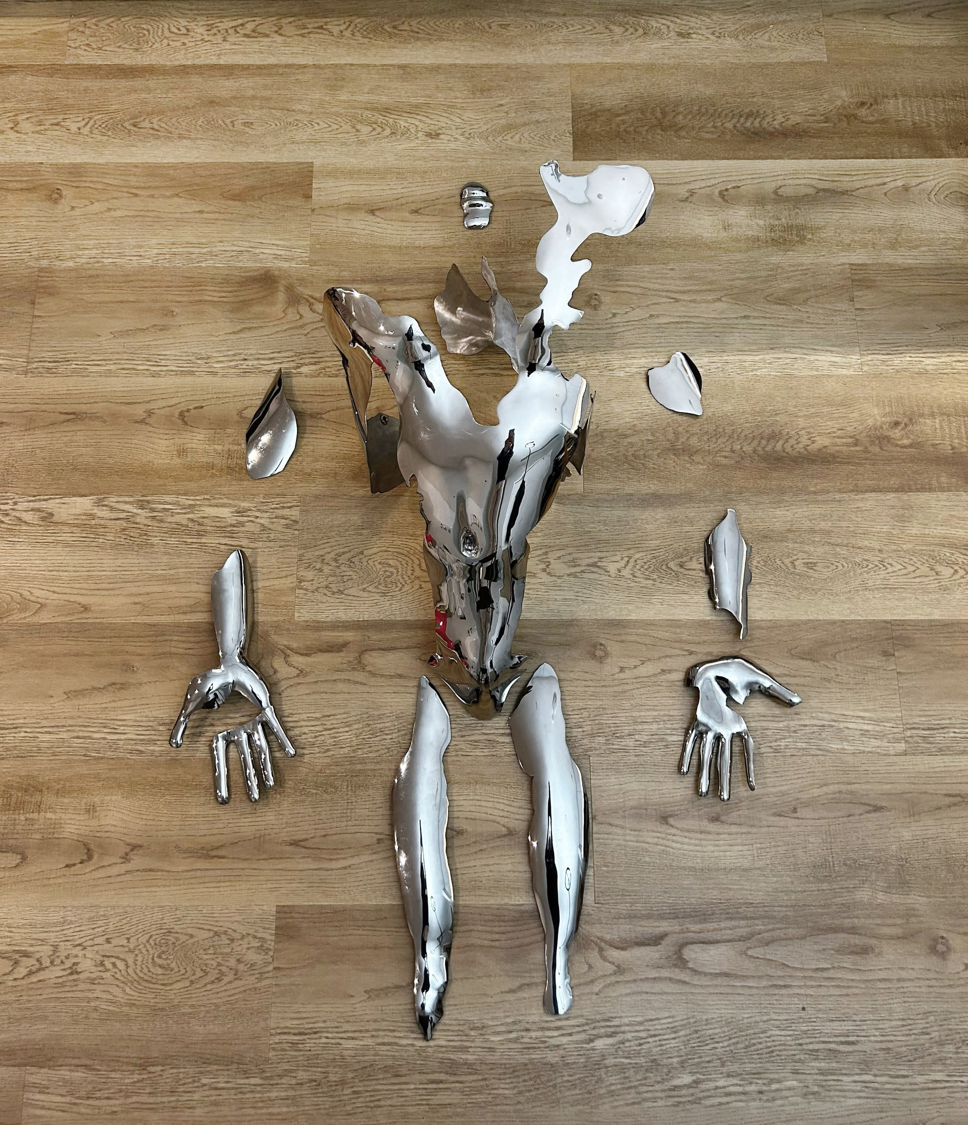 Stainless steel surface pieces of a male body lying limp