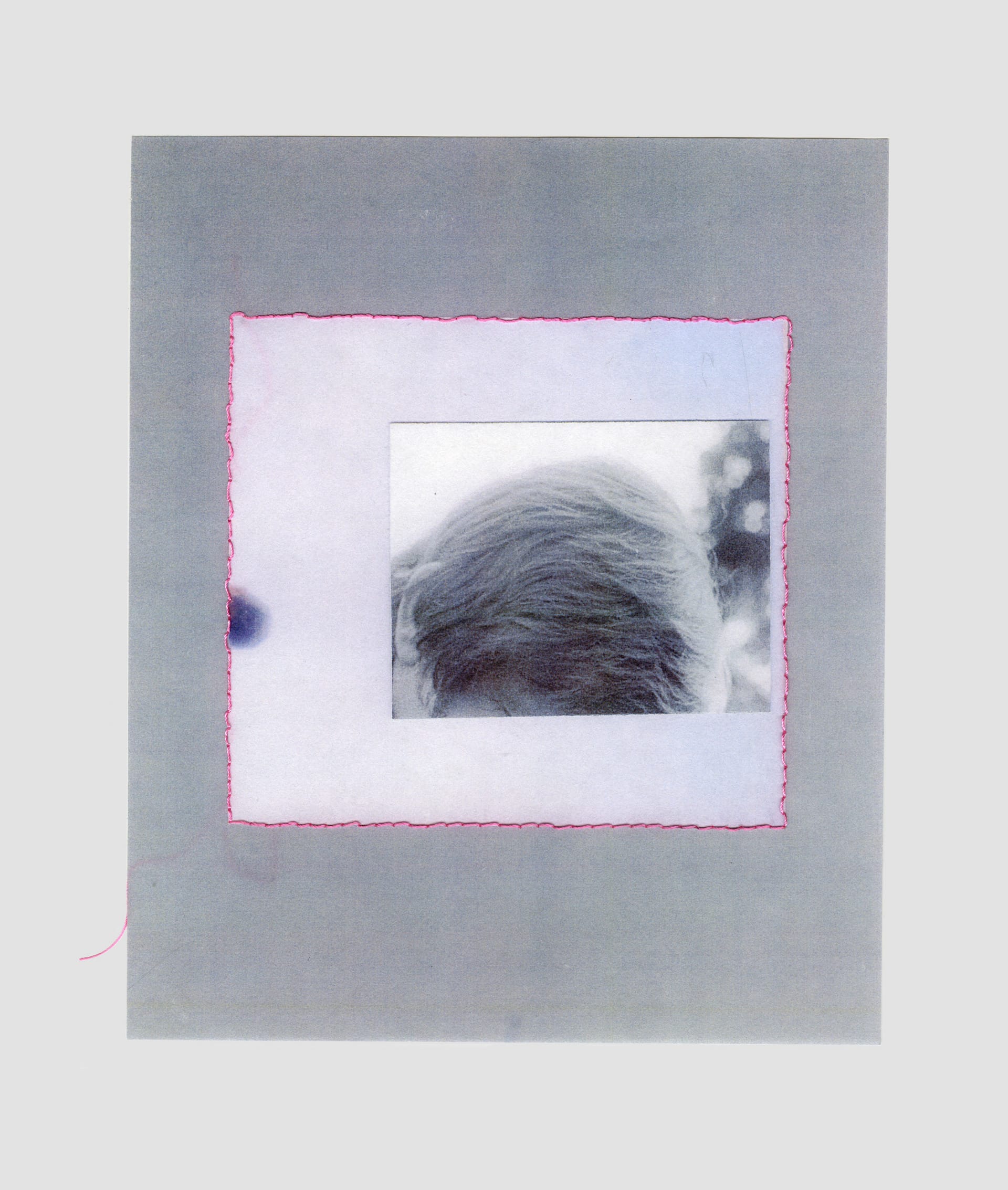 A collage with a greyscale photograph of the top of a man's head. The collage is outlined with a pink square of back stitch