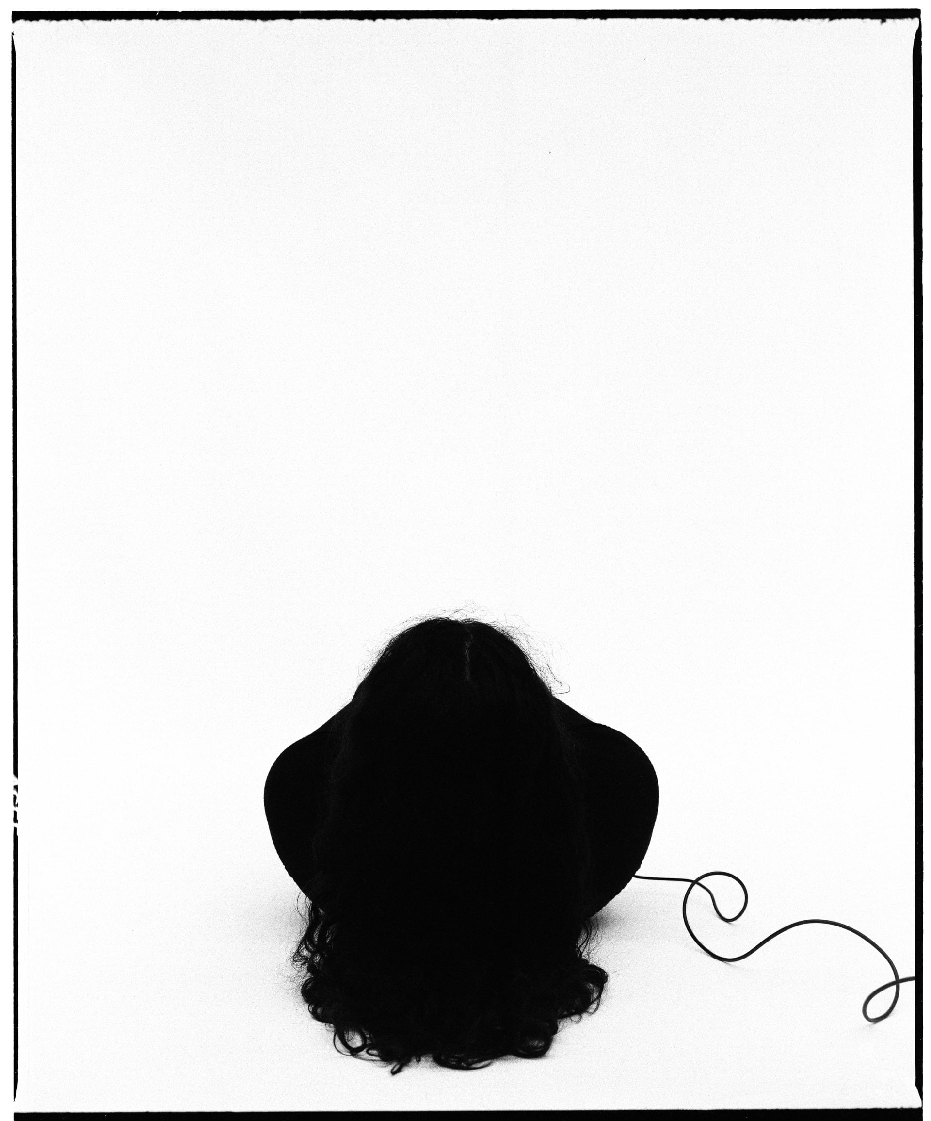 black and white self-portrait, laying on back away from the camera, body obscured by head and shoulders