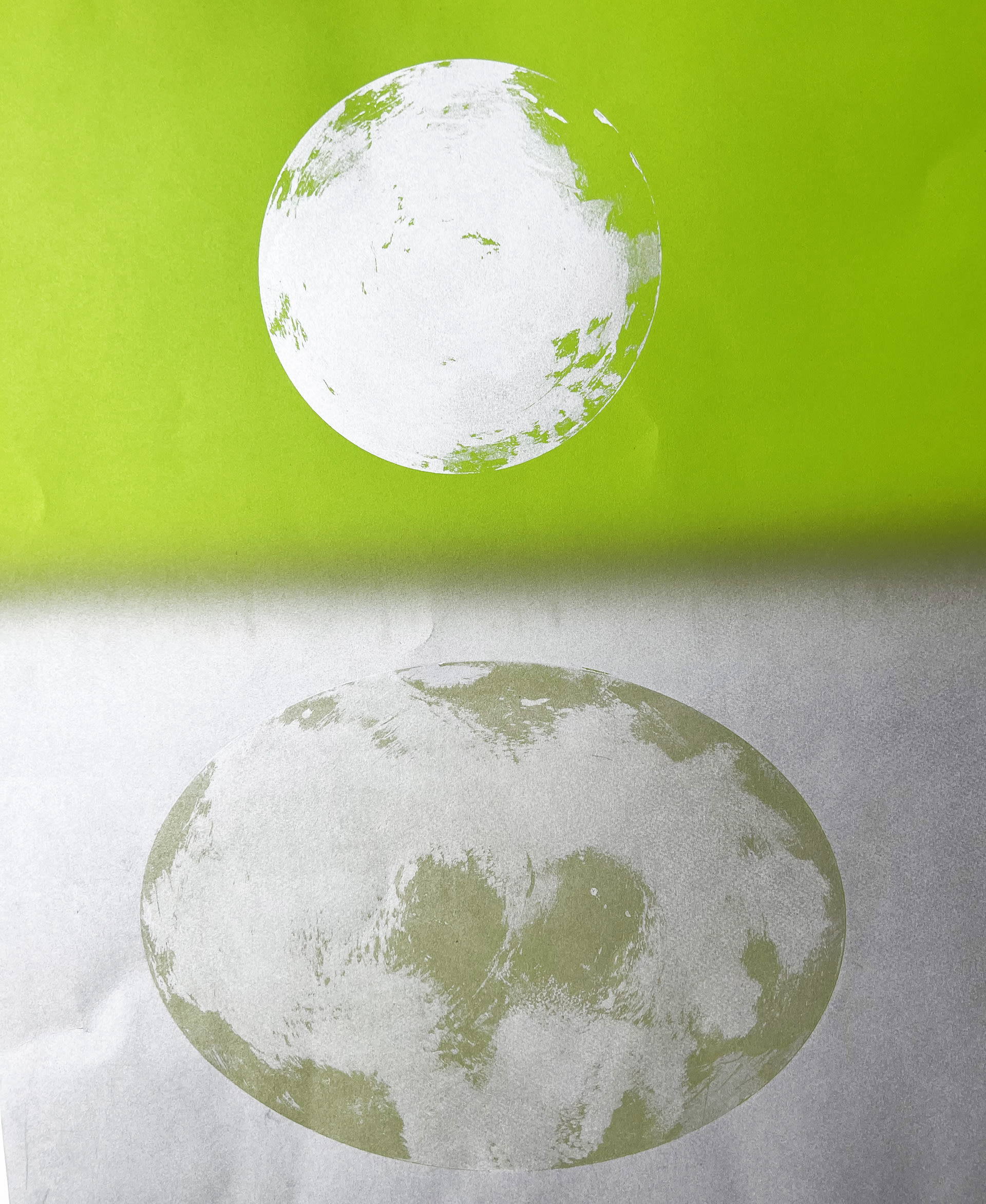 Monoprint made with circular images of green and silver.