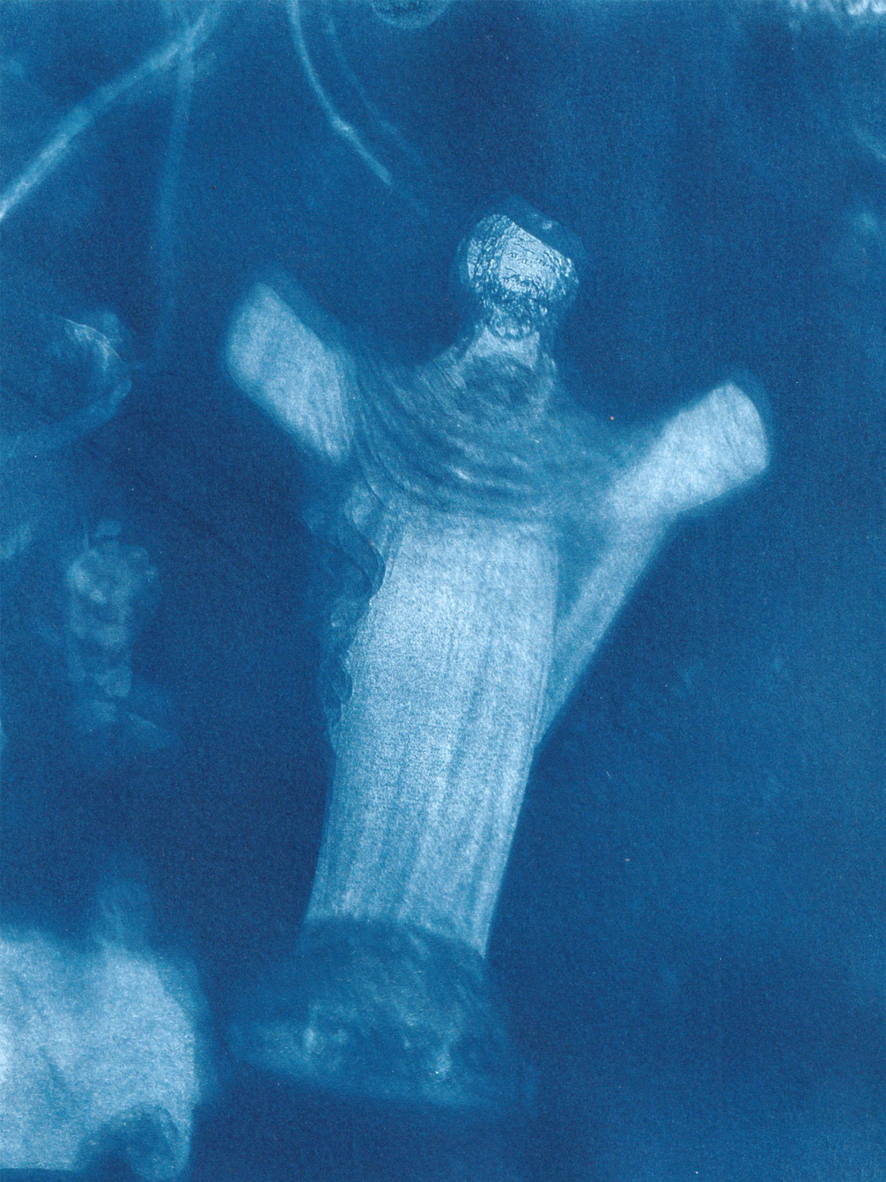 a print on paper of a faded ghostly figure - jesus with no hands. other parts of the paper are faded with blurred objects. 