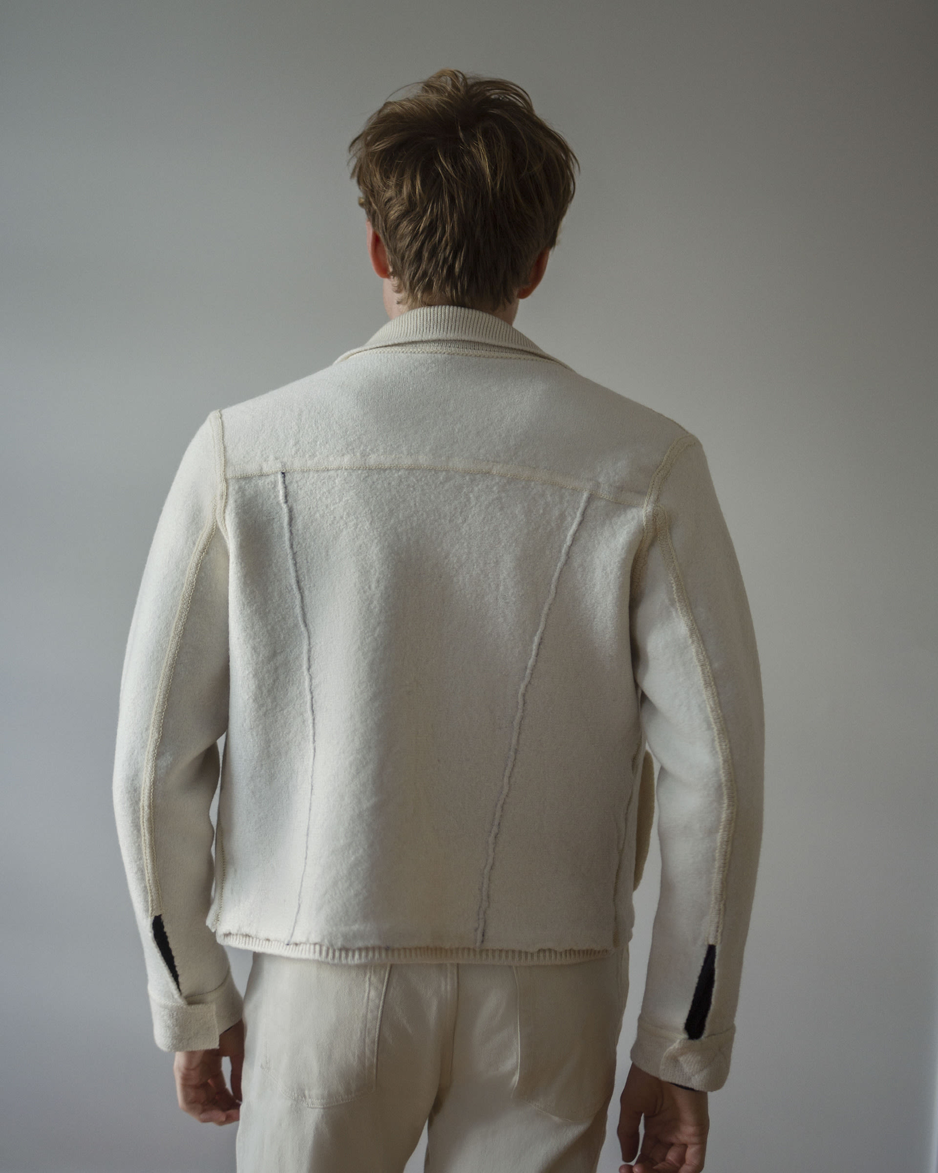 back of jacket shown on white male with short brown hair