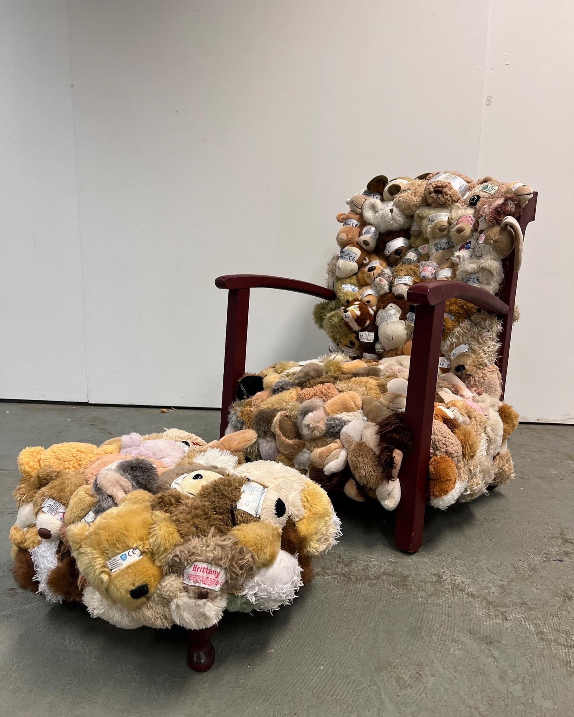 A chair and a stool made from soft toy body parts.