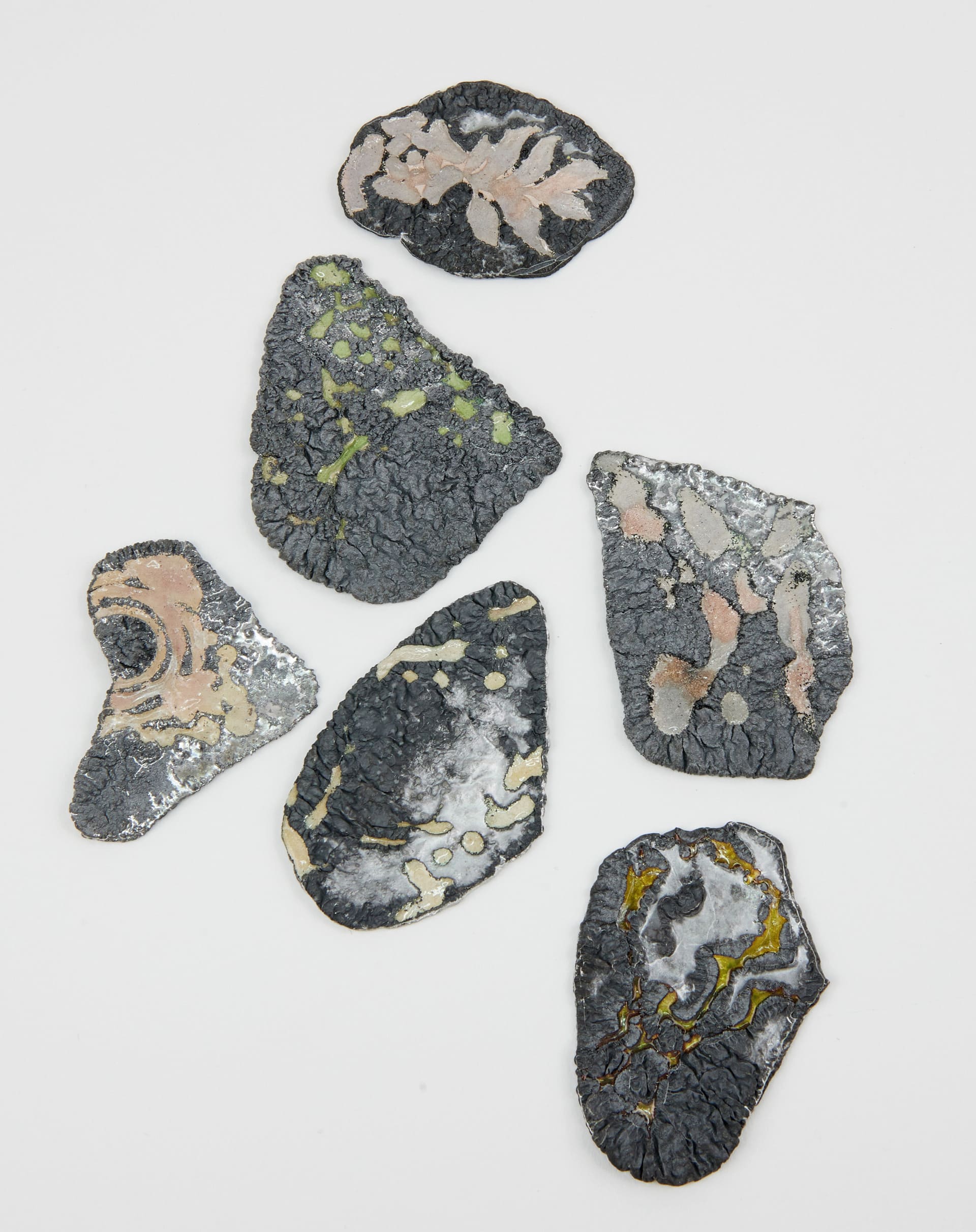 group of 6 silver fragments with coloured glass enamel across the surface
