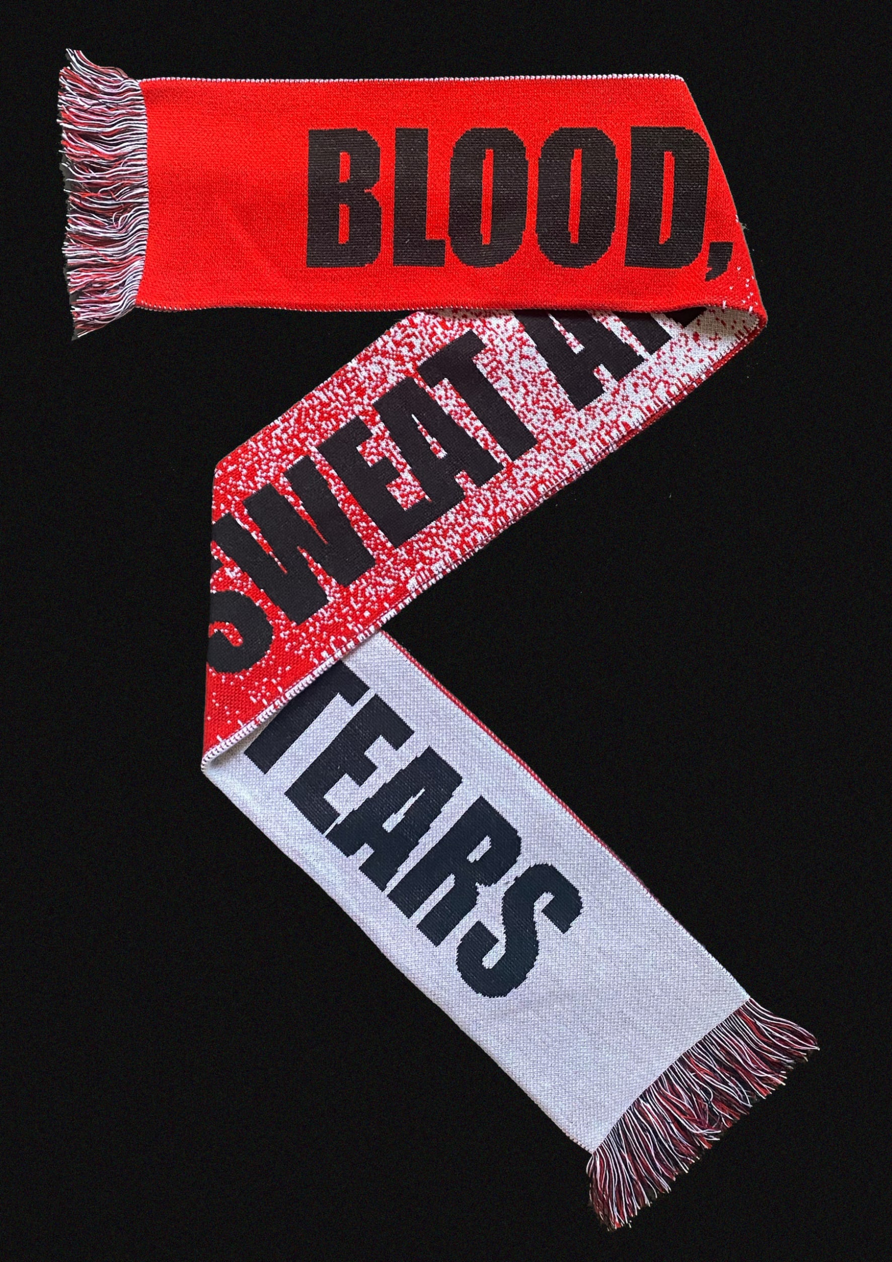 Red and white scarf that says Blood Sweat and Tears