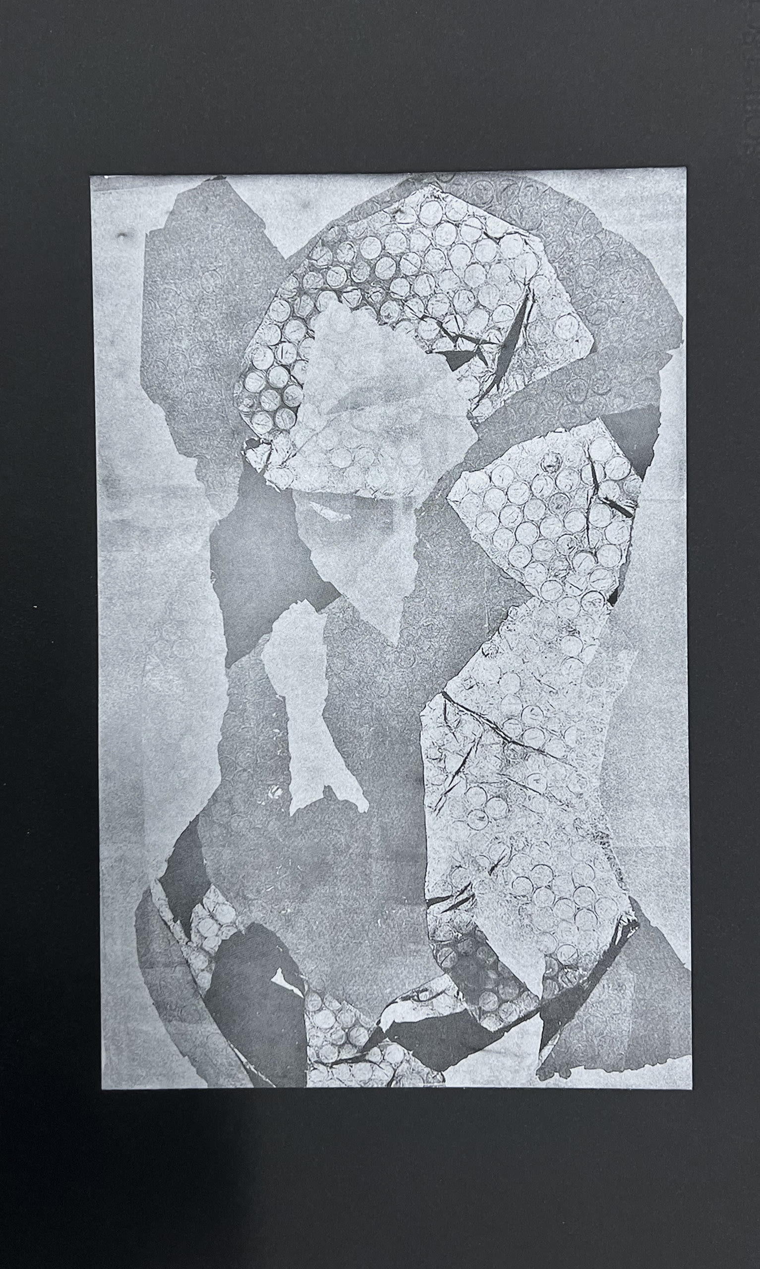 Silver collaged image of a body torso on a black background. Photopolymer.