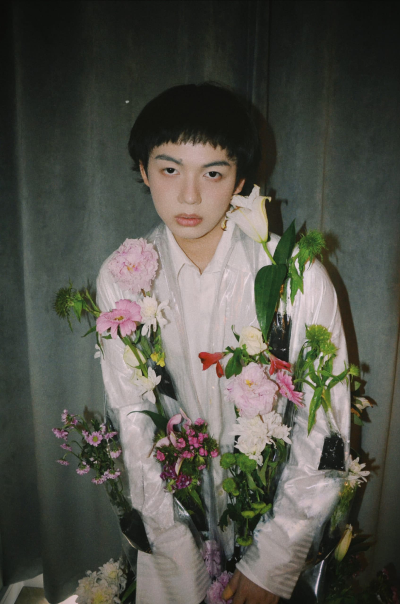 Model wearing a transparent jacket filled with flowers